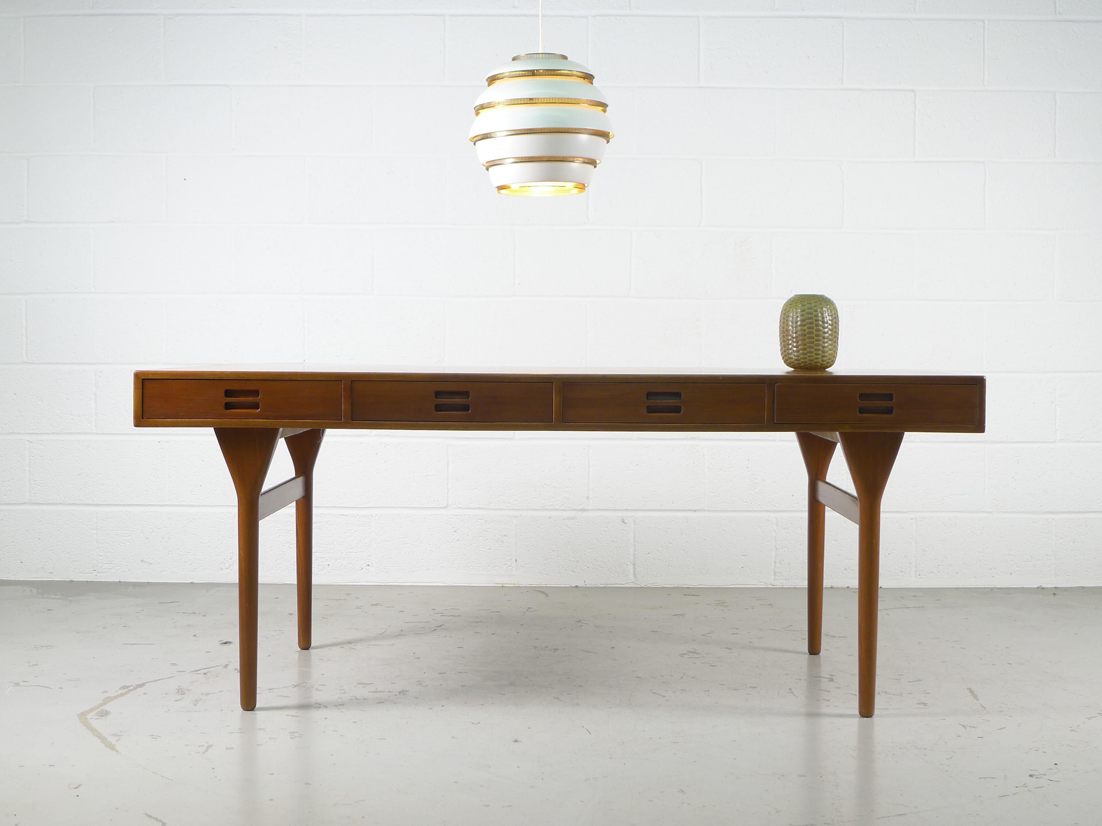 Nanna & Jorgen Ditzel for Søren Willadsen, Denmark, 1958. Four drawer solid teak desk , drawer fronts with the early inbuilt pulls . 
Classic desk in excellent overall condition , one very small area to the top front left appears slightly lighter.