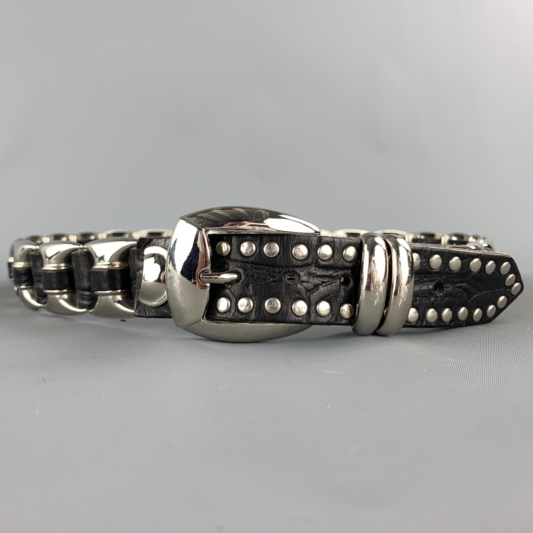 NANNI belt comes in a black & sliver leather with a studded design throughout featuring a silver tone buckle closure. Made in Italy.

Very Good Pre-Owned Condition.
Marked: 90/36

Length: 40.5 in.
Width: 1 in. 
Fits: 33 in. - 36 in.
Buckle: 1.5 in. 