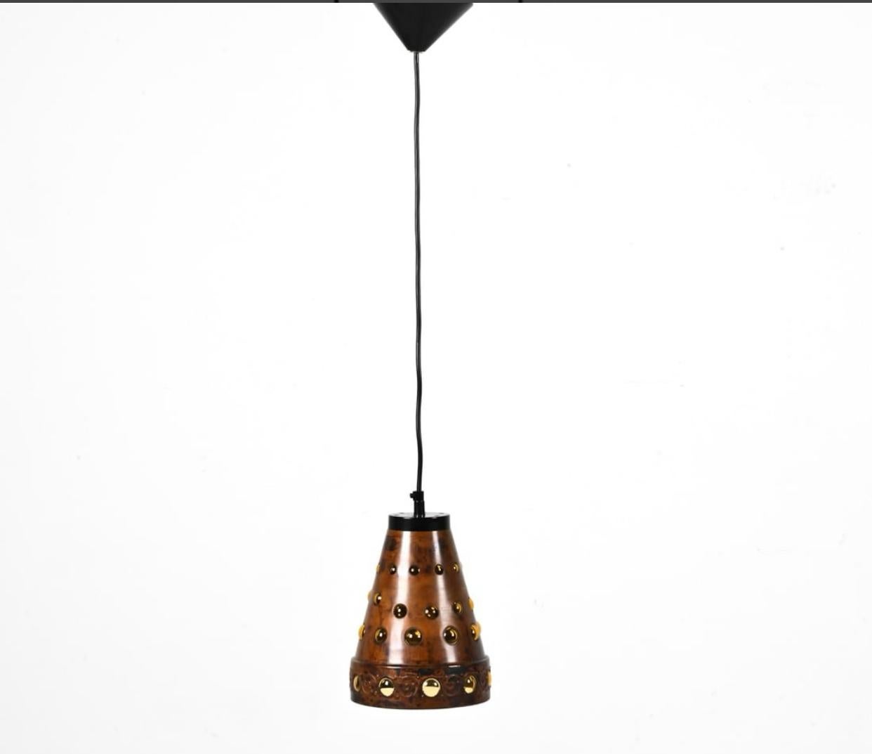 Pair of copper and blown glass pendant light by Nanny Still McKinney for RAAK of Amsterdam. The pendant lights themselves measure 6.5” dia. X 8.75” h without cord and canopy. We have the ability to make the lights any height with changing out the