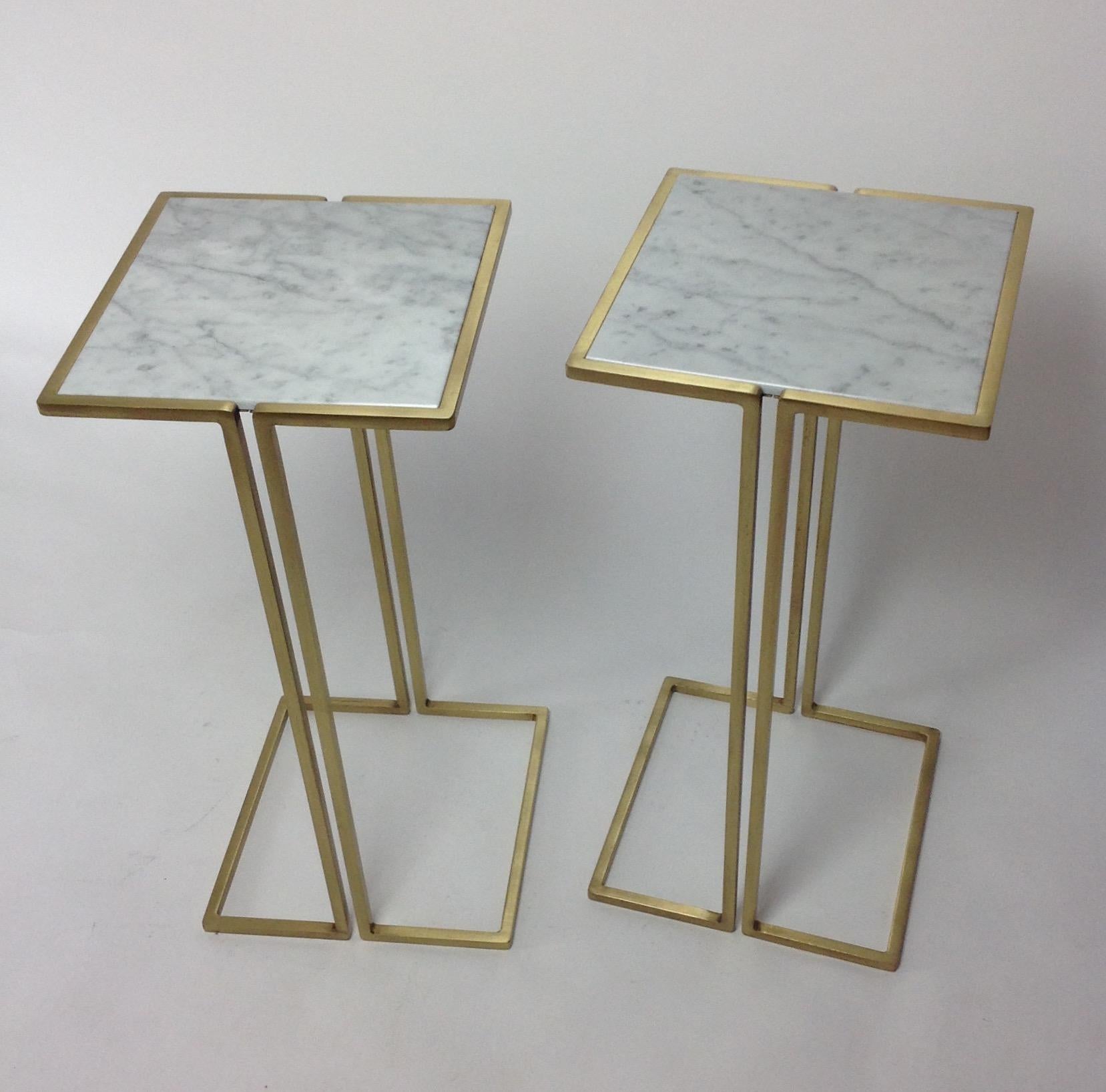 Small-scale side tables which have a Minimalist design with a satin brass plated frames and marble tops. They are versatile tables, perfect for cocktails or laptops. They can also work nicely as bedside tables. These side tables nestle nicely around