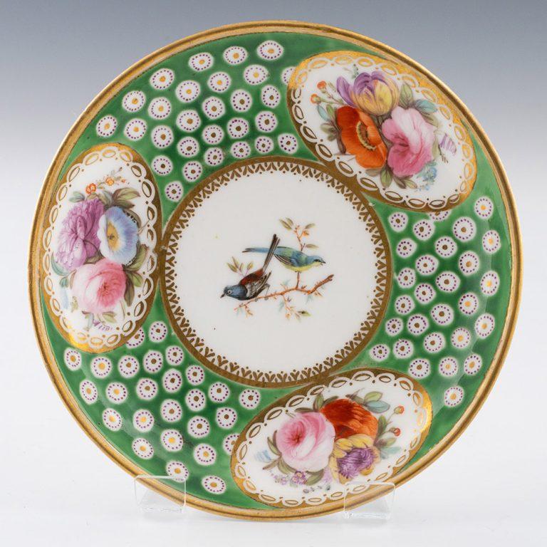 Heading : Nantgarw porcelain teacup and saucer
Date : 1818-20
Period :Regency
Origin : Nantgarw, Wales. Probably London decorated
Colour : Polychrome
Pattern : Three garden flower panels with gilt borders and apple green ground containing gilded