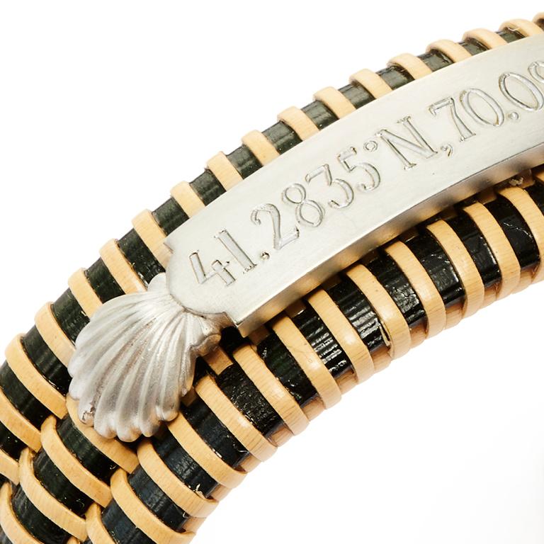 Hand woven Ebony Nantucket Basket Bracelet™ with Sterling Silver Scallop Shell Quarterboard and endcaps. Shown here with the coordinates for Nantucket.
May also be custom engraved with your name, your house, your boat, your choice!

Price is
