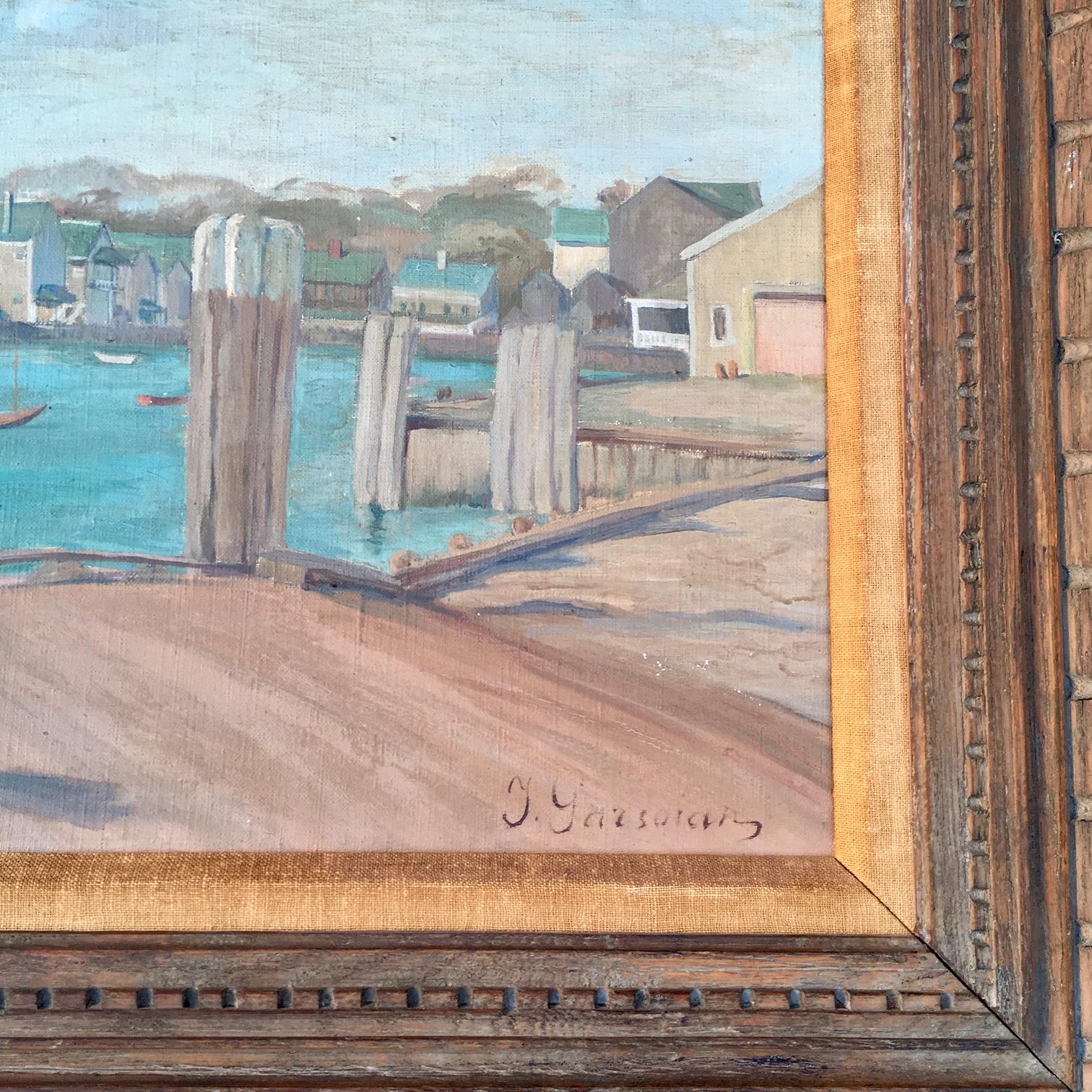 Nantucket Harbor Scene, by Inna Garsoian (1896–1984), circa 1946, oil on canvas view of wharves and waterfront from vantage of old Steamship office, signed lower right, and signed and dated on the reverse, mounted in original hand carved wooden