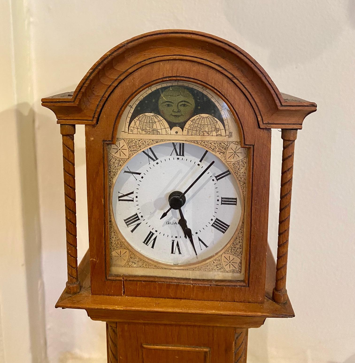 Rare Antique Nantucket miniature long case clock, made and patented by Wallace Brown, circa 1894, with original paper label and poem. A Hand crafted mahogany case with arched bonnet, turned columns flanking the decorated face and dial. Found on