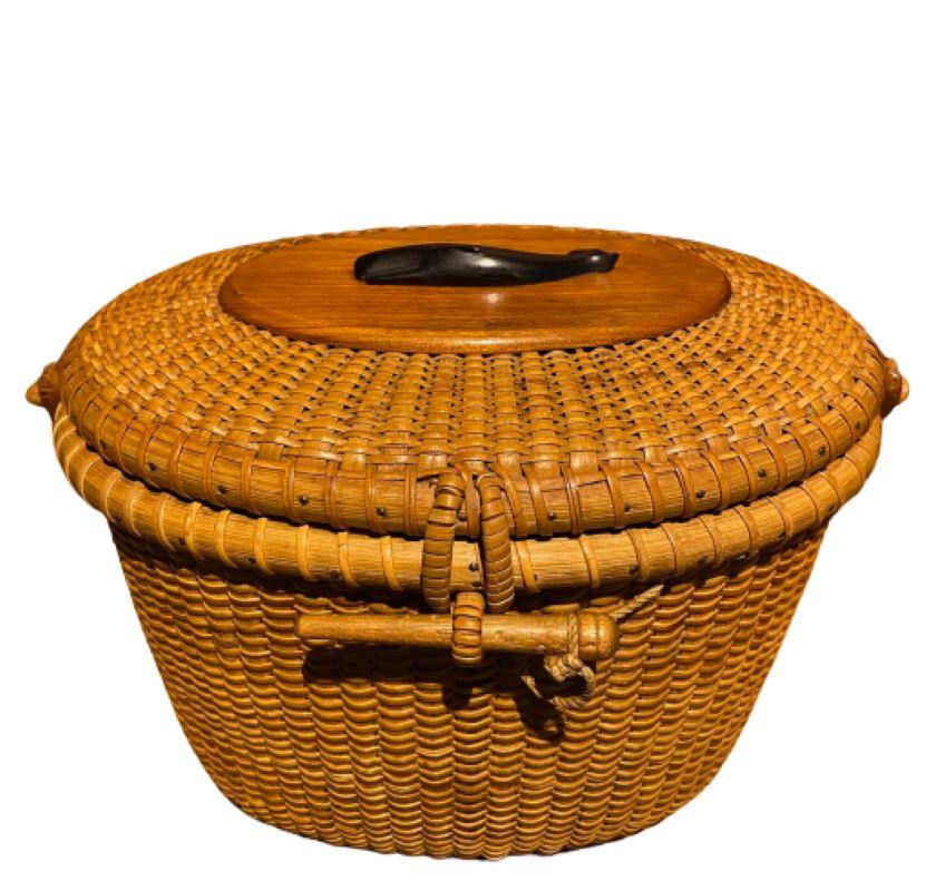 Nantucket Purse by Jose Formoso Reyes, circa 1950, a very early Nantucket woven purse from during the first few years Reyes was making Nantucket baskets, having a cane weave on rattan staves, with carved swing handle mounted with petite whittled