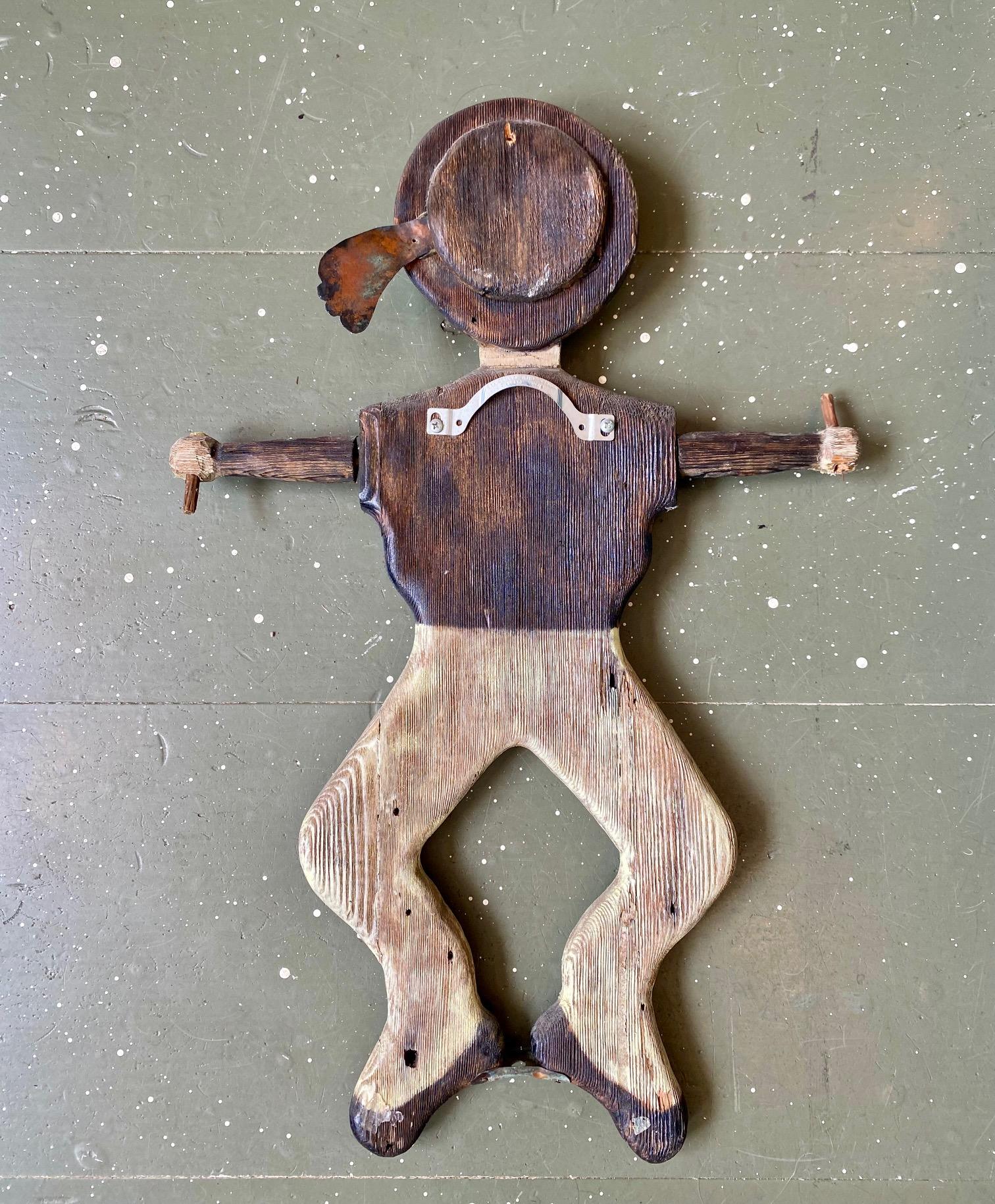 Antique Nantucket Sailor Boy Whirligig, circa 1880, by either Billy Ray or Charles C. Ray (born 1824), a hand carved flat figure of a sailor in brown and white paint, wearing round cap with metal ribbon, loose sailor's blouse and pants, and carved