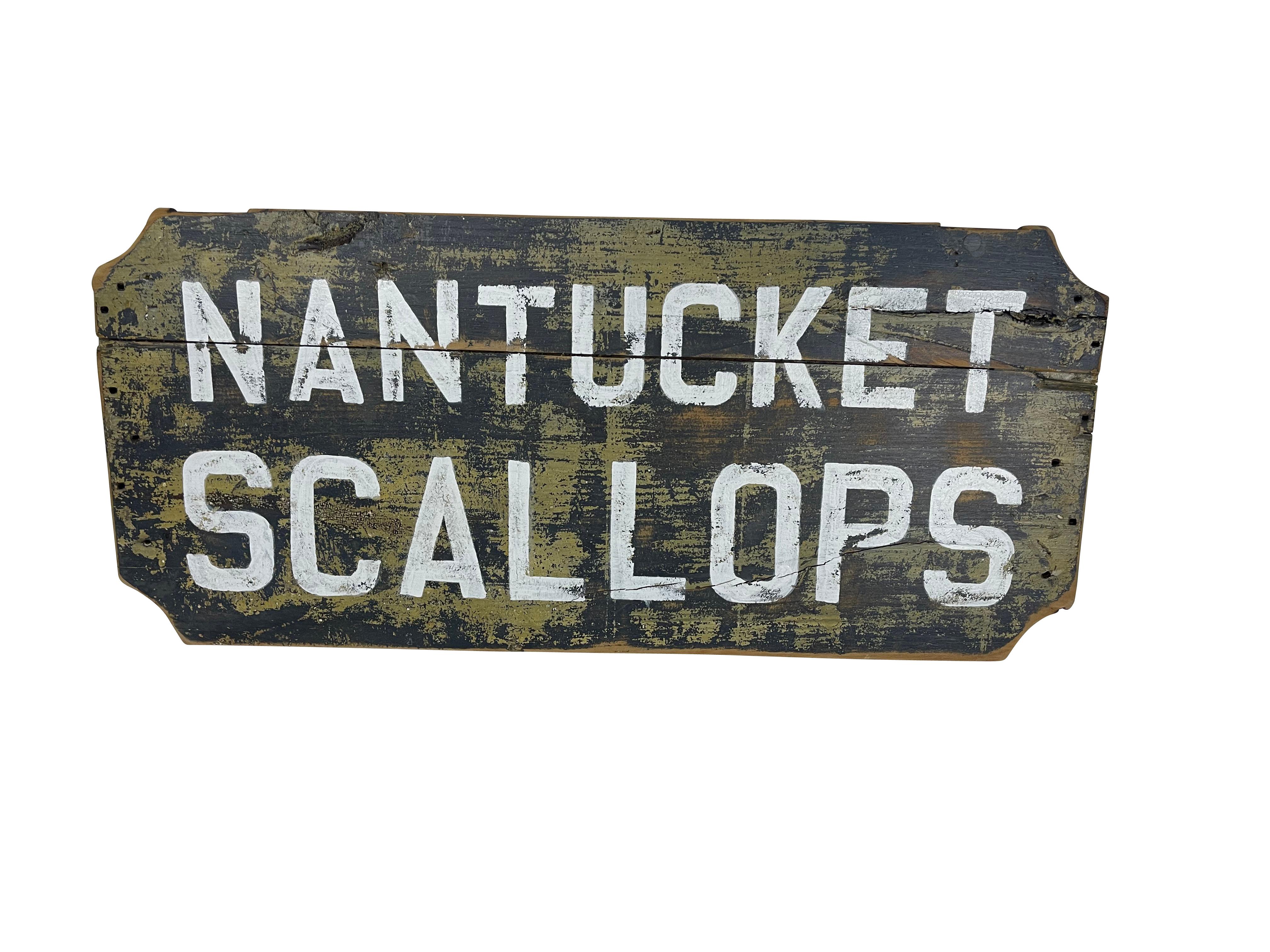 Excellent old Nantucket Scallop sign with notched corners on old wood with white hand-painted letting.  The back is covered with old newspaper. Old wood shows wear and cracking, which adds to its charm.  Ready to hand on your beach house wall!