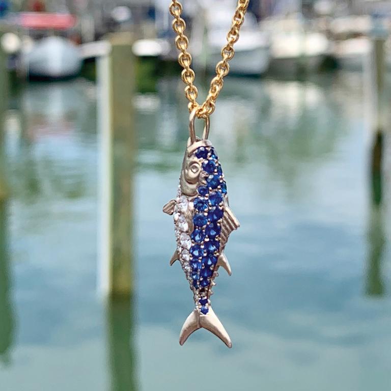 Make one your catch of the day.

18 Karat White Gold Nantucket Tuna Fish Pendant, set with Sapphires. (pictured left)

Chain and 18 Karat Gold clasp sold separately.

***Please note: The listed price reflects a single Sapphire Pendant (as shown on