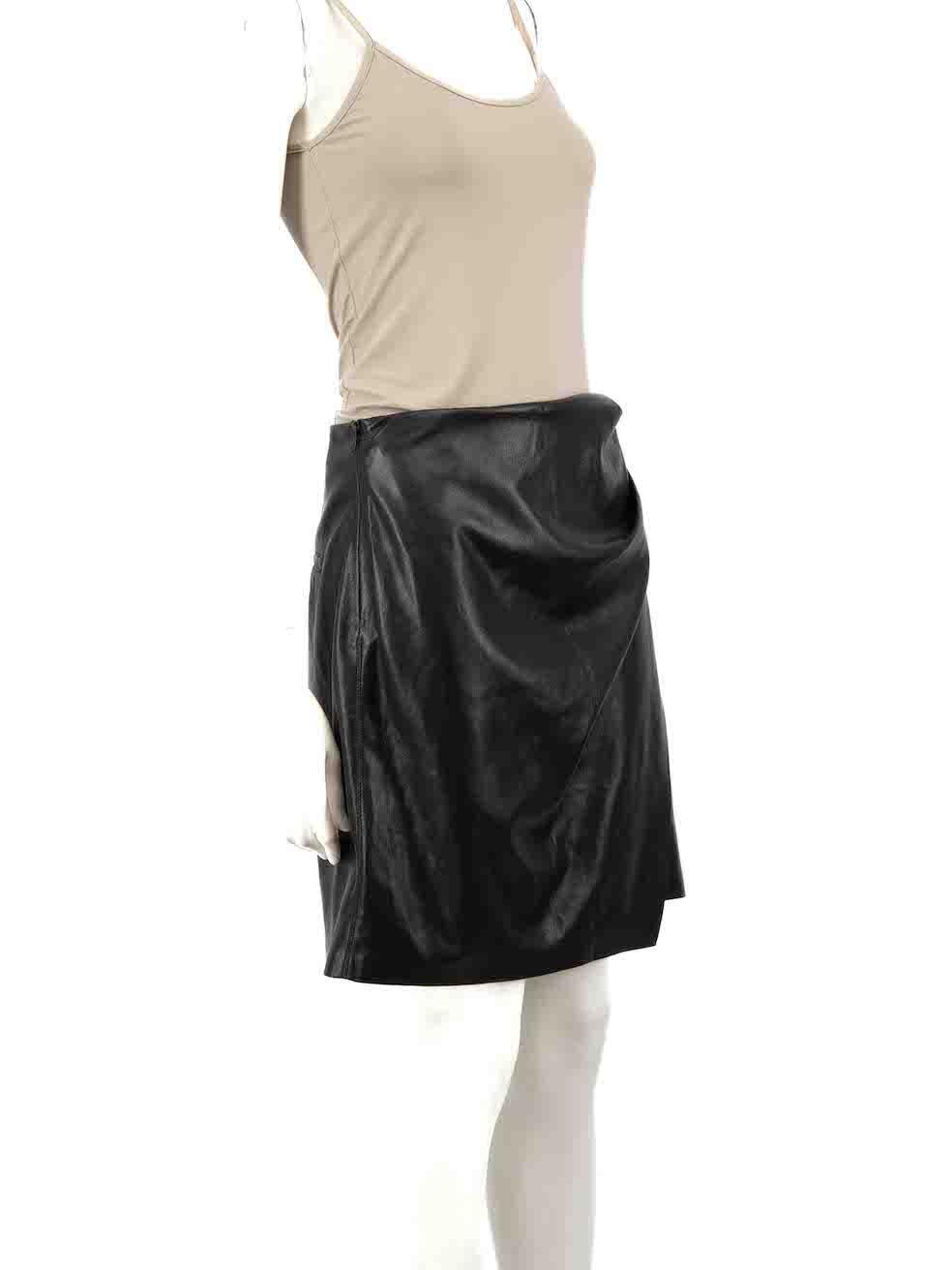 Condition
 
 CONDITION is Very good. Hardly any visible wear to skirt is evident on this used NANUSHKA designer resale item.
 
 Details
 
 
 
 Black
 
 Vegan leather
 
 Wrap skirt
 
 Mini length
 
 Ruched accent
 
 Side zip closure
 
 
 
 
 
 Made