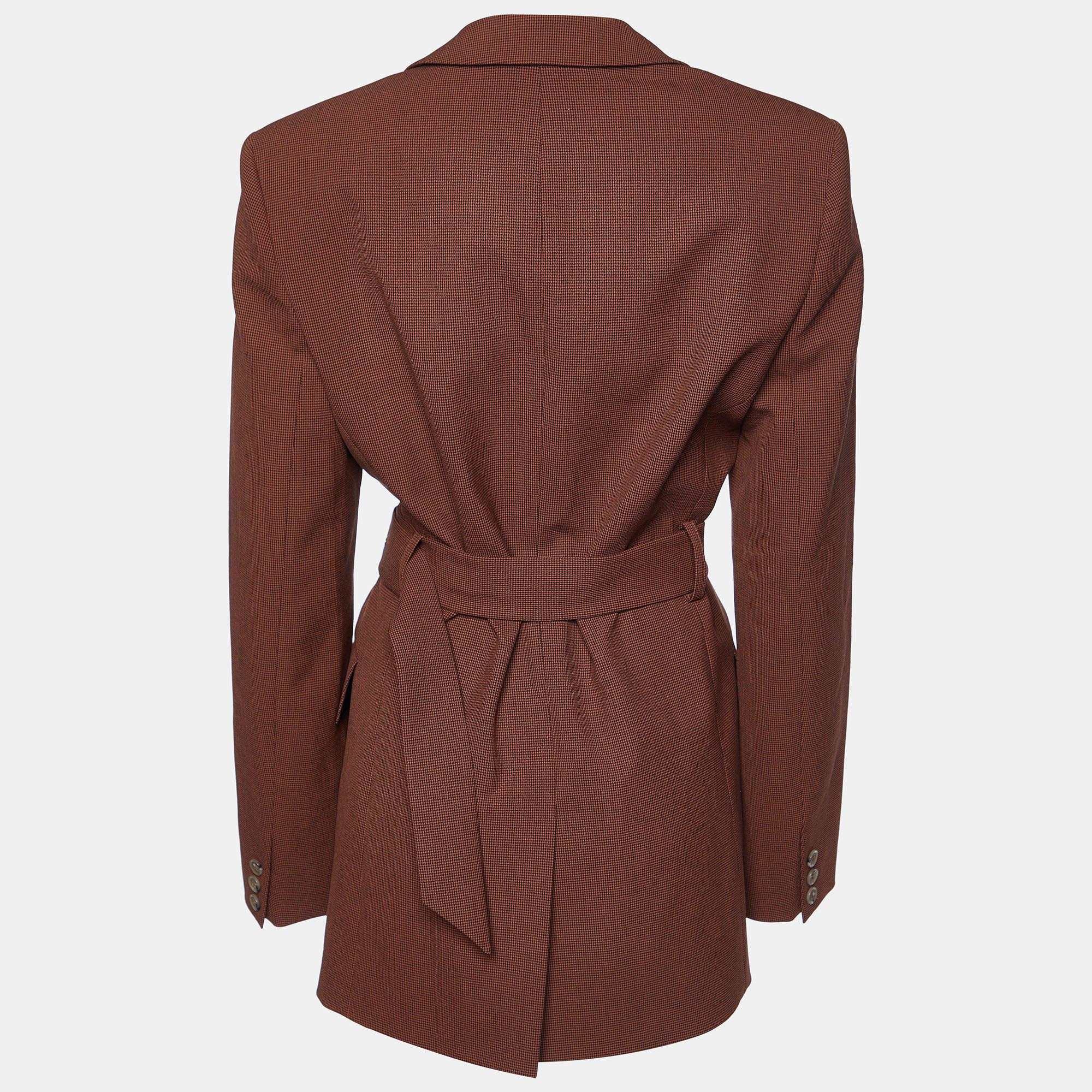 Wrap yourself in timeless elegance with the Nanushka blazer. Crafted with exquisite attention to detail, this blazer features a classic brown houndstooth pattern, a flattering belted waist, and a sophisticated silhouette that effortlessly exudes