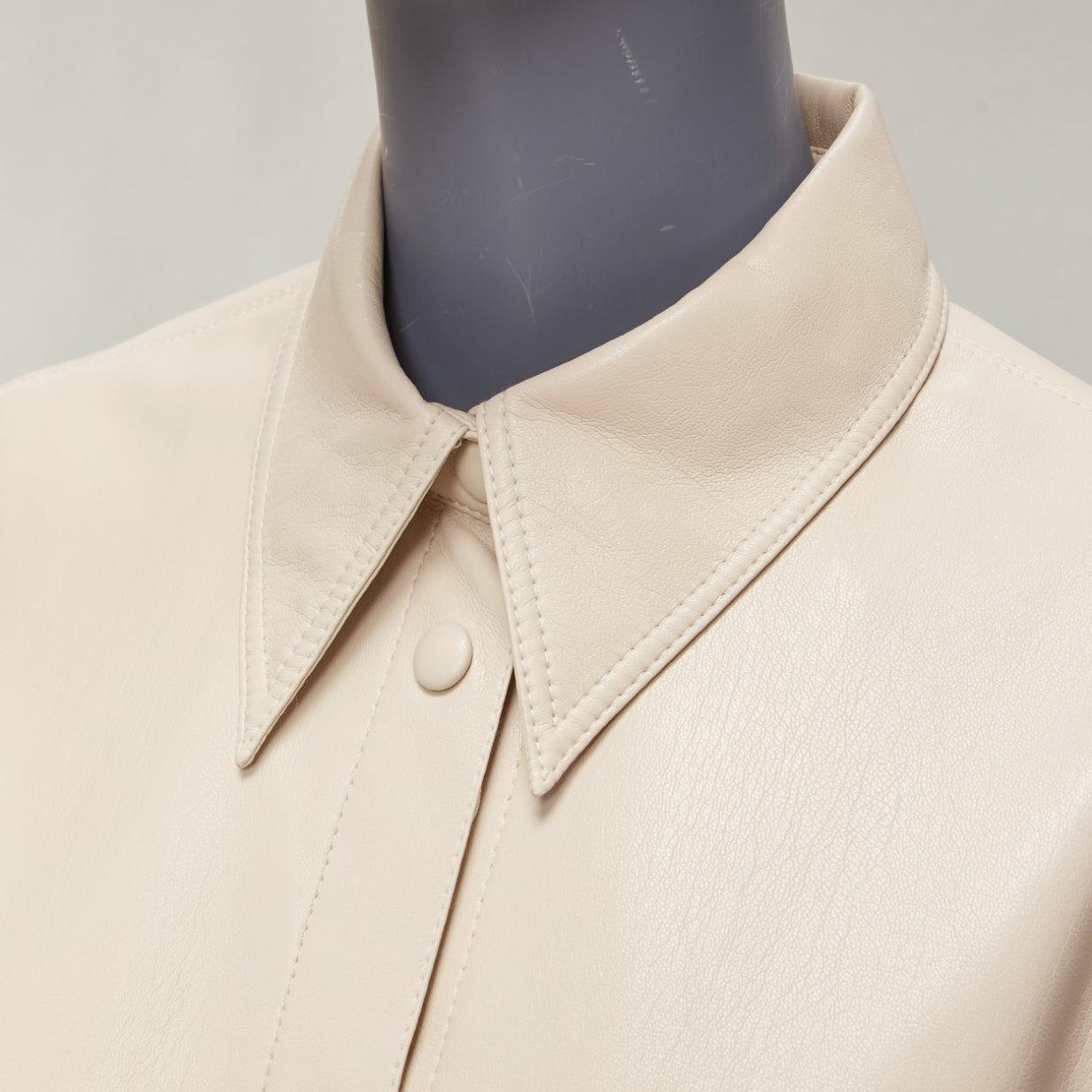 NANUSHKA stone beige vegan leather panels hidden placket minimal shirt XS
Reference: KYCG/A00023
Brand: Nanushka
Material: Faux Leather
Color: Beige
Pattern: Solid
Closure: Button
Extra Details: Hidden plackets.
Made in: