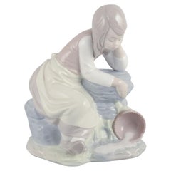 Nao, Spain. Porcelain figurine of a girl taking a rest. Ca 1980s.