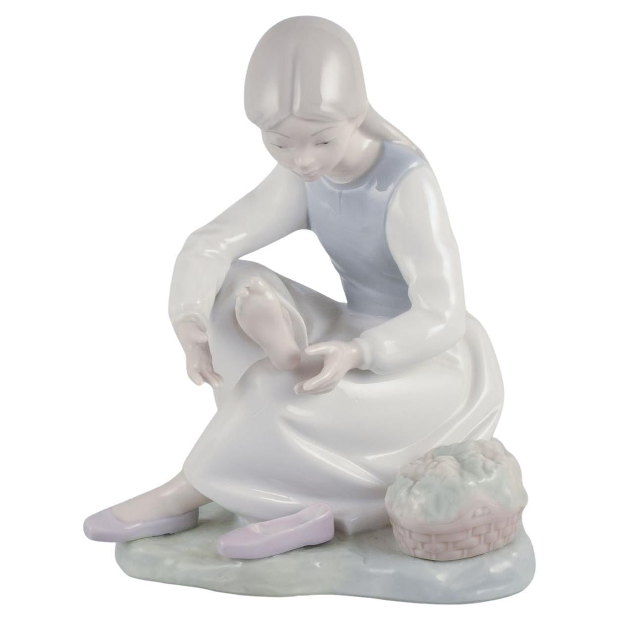 Nao, Spain. Porcelain figurine of a girl taking a rest. Ca 1980s.