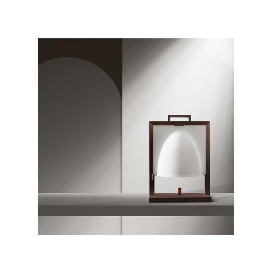 Naos means temple in Greek
Table lamp with the structure in solid polished maple and metal.
The lampshade is in press-molded, oven glazed glass. A knob in solid pau ferro is located at the center of the base and it is used for changing light