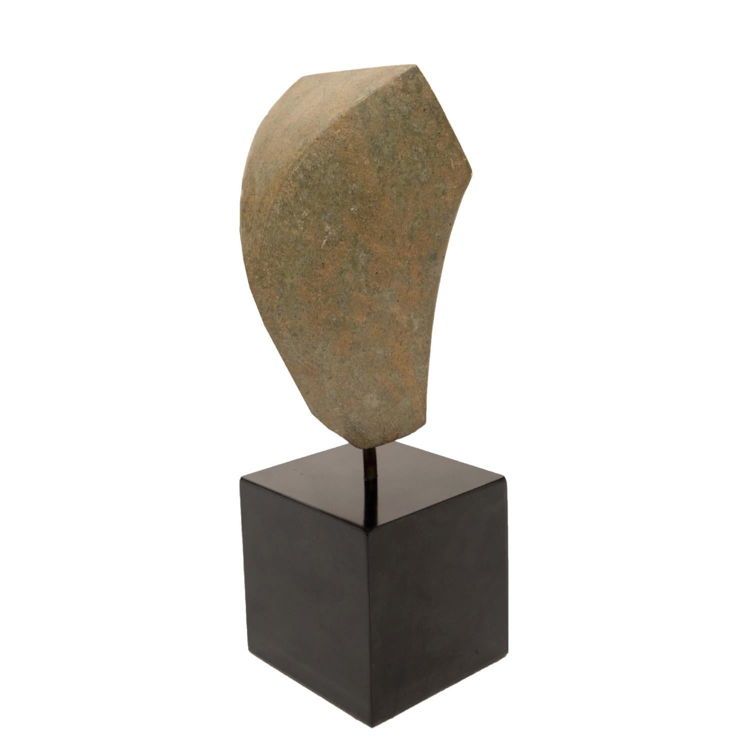 Hand carved sculpture “Lithic” in Green Italian granite on an ebonized wood base by Naomi Feinberg, American, 1970s.

Naomi Feinberg was a New York based sculptor who worked primarily in stone. She began sculpting in the 1940s and became