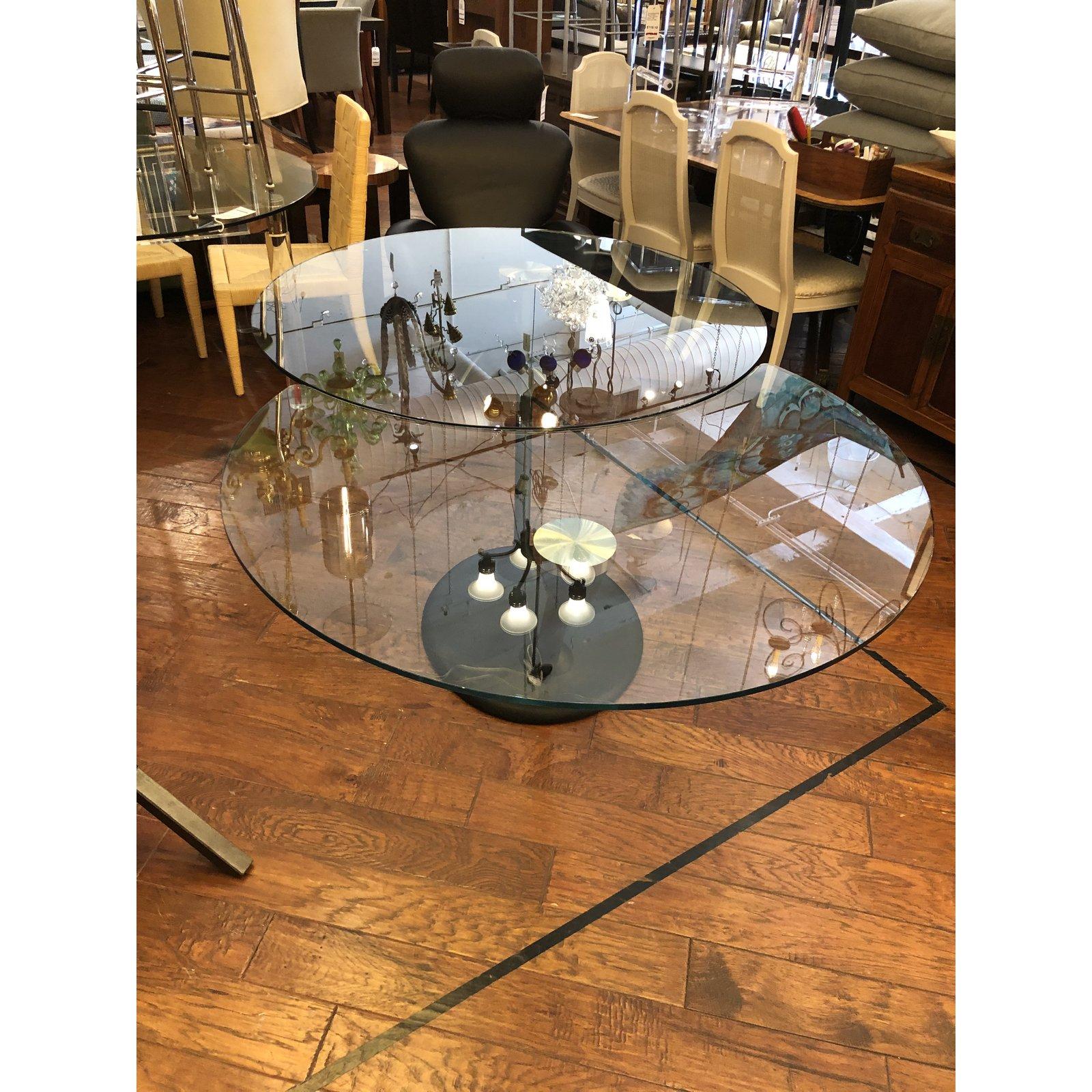 We presents a Hula Op dining table by NAOS. Manufactured by Naos and designed by Arnaldo Gamba and Leila Guerra. Two large glass tops are UV glued to 2 offset steel supports. Equipped with an original mechanism that allows a synchronized movement to