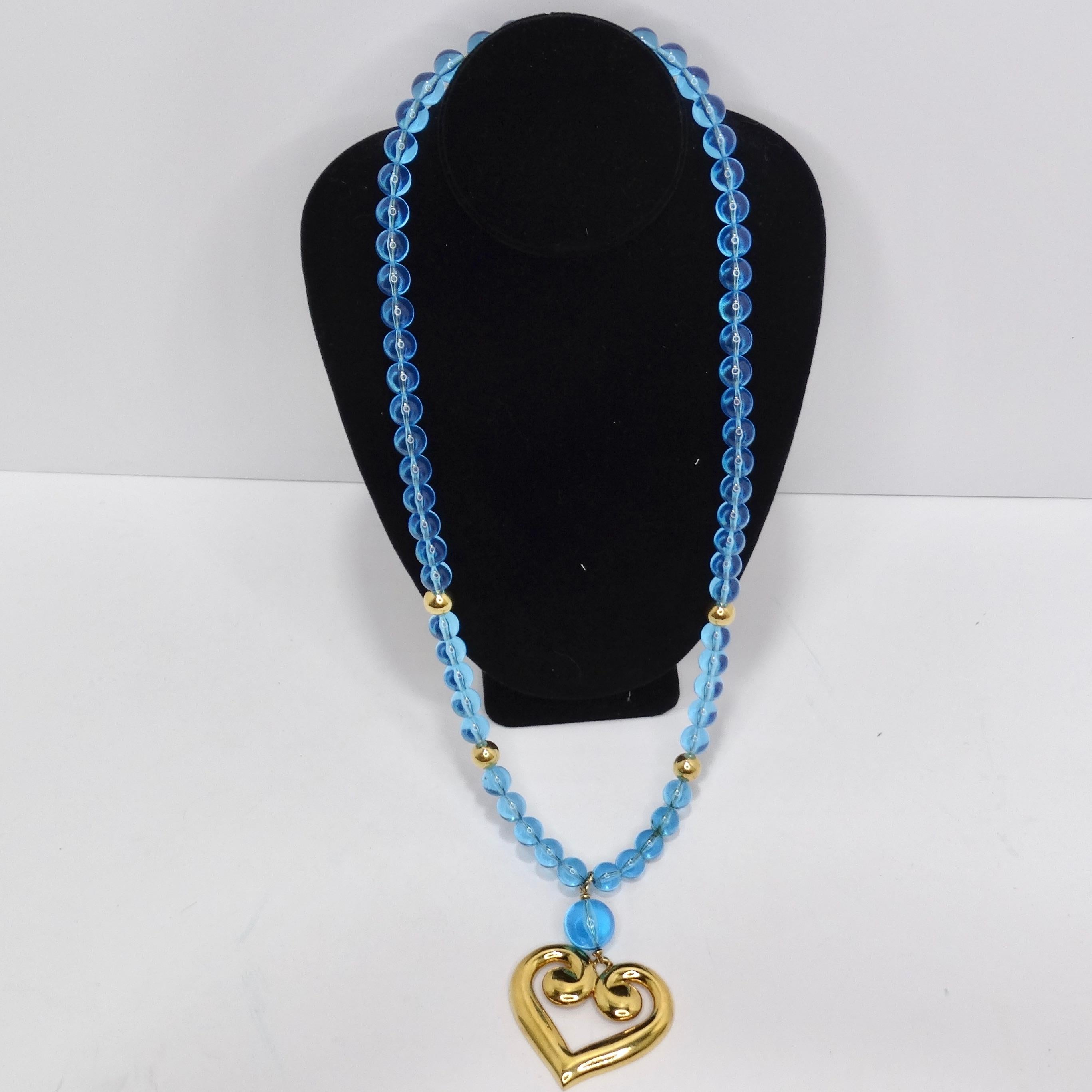 Embrace the vibrant allure of the 1980s with our captivating Napier 18K Gold Plated Greek Heart Blue Bead Pendant Necklace. This dramatic and long necklace features a multitude of electric blue beads that gracefully contrast with the lustrous 18K