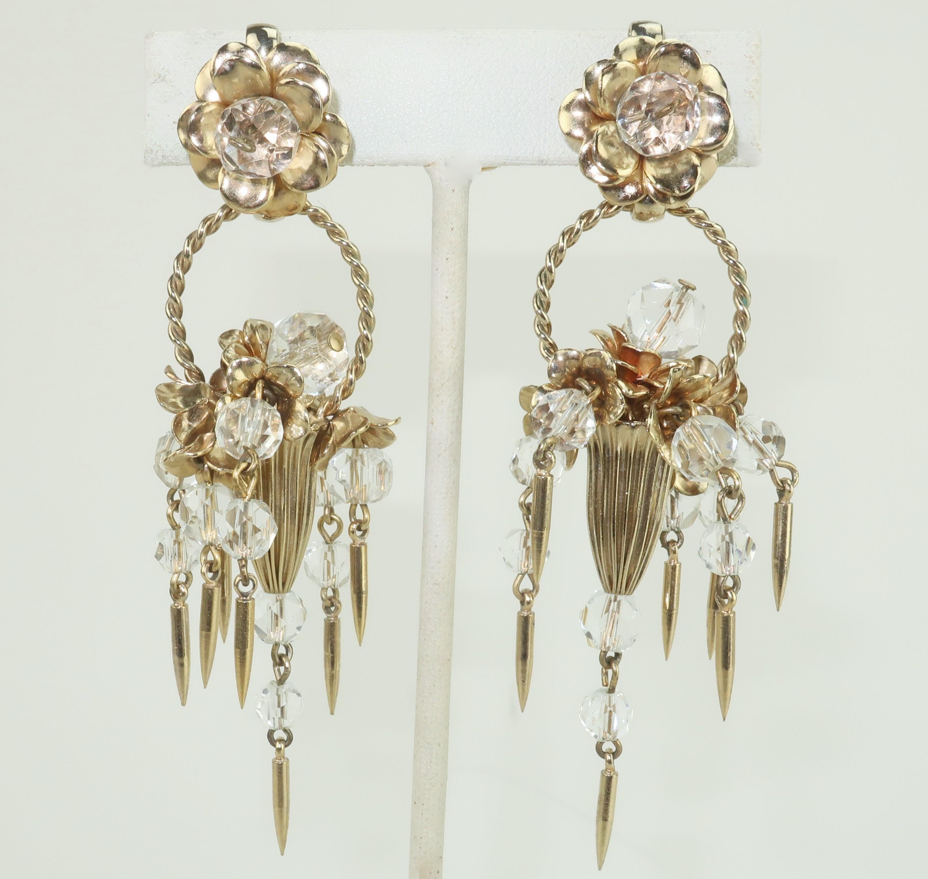 A beautiful pair of 1950's flower basket earrings by the venerable American costume jewelry company, Napier.  The intricate chandelier style gold tone earrings are decorated with faceted crystal beads and dagger shaped drops that create a design