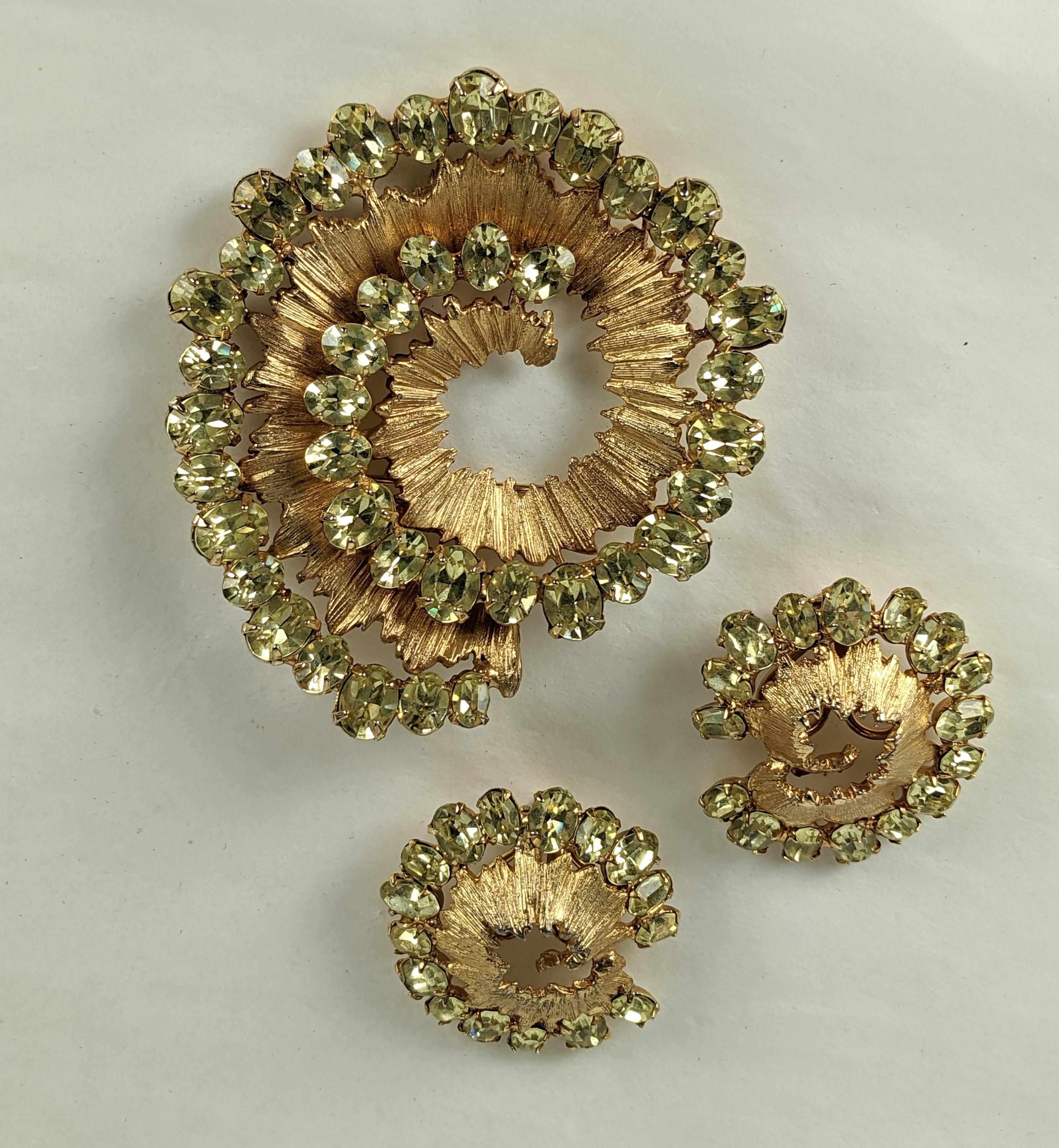 Unusual Napier Modernist Swirl Citrine Stone Suite. Brooch with earrings with clip back fittings. A gilt striated coil motif is edged with dozens of oval citrine pastes.  1960's USA. 
Brooch 2.5