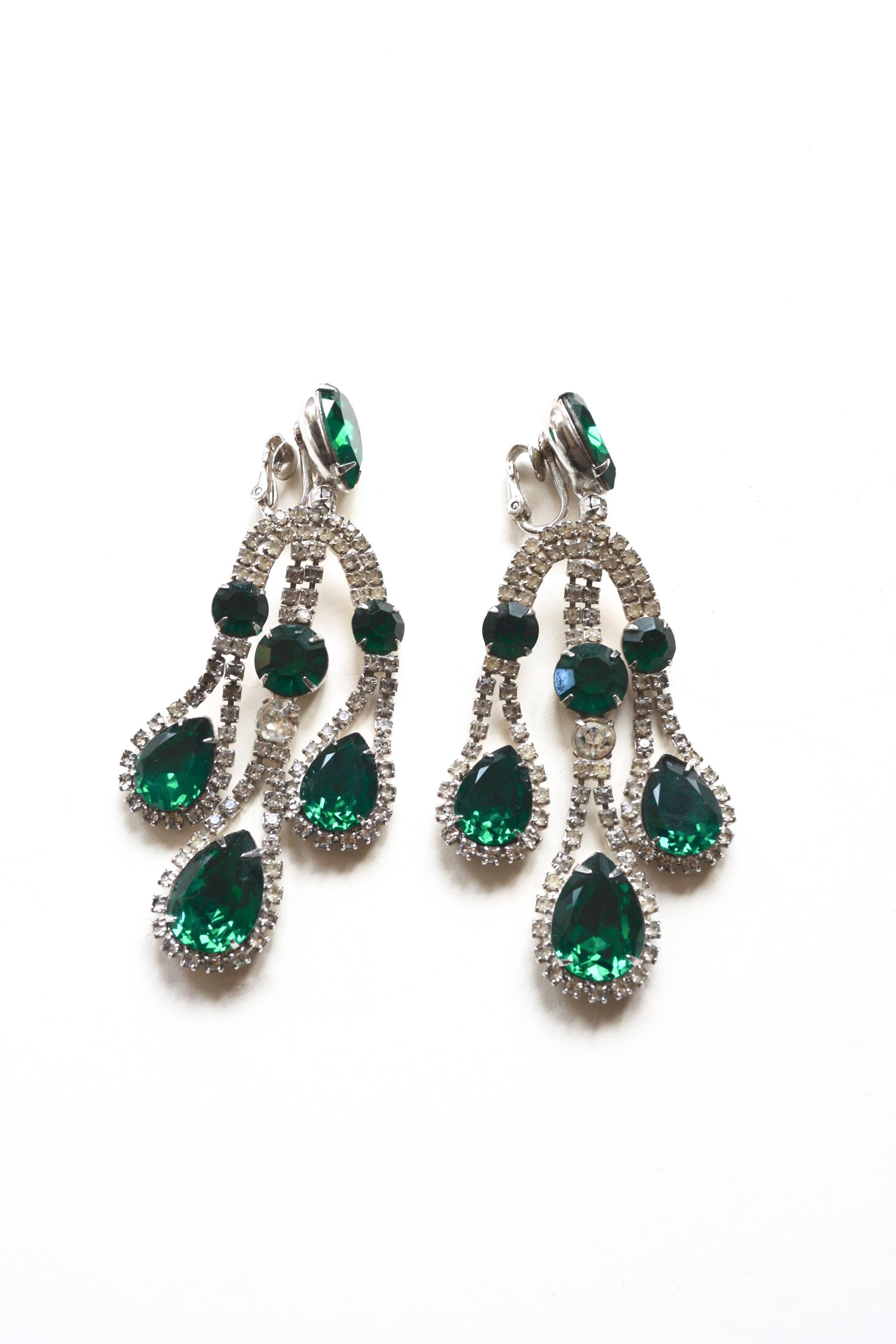 1960s signed Napier large emerald and rhinestone chandelier earrings. Unique design and wearable.  Good condition overall with mild stone wear to a few stones. Measures 3.5