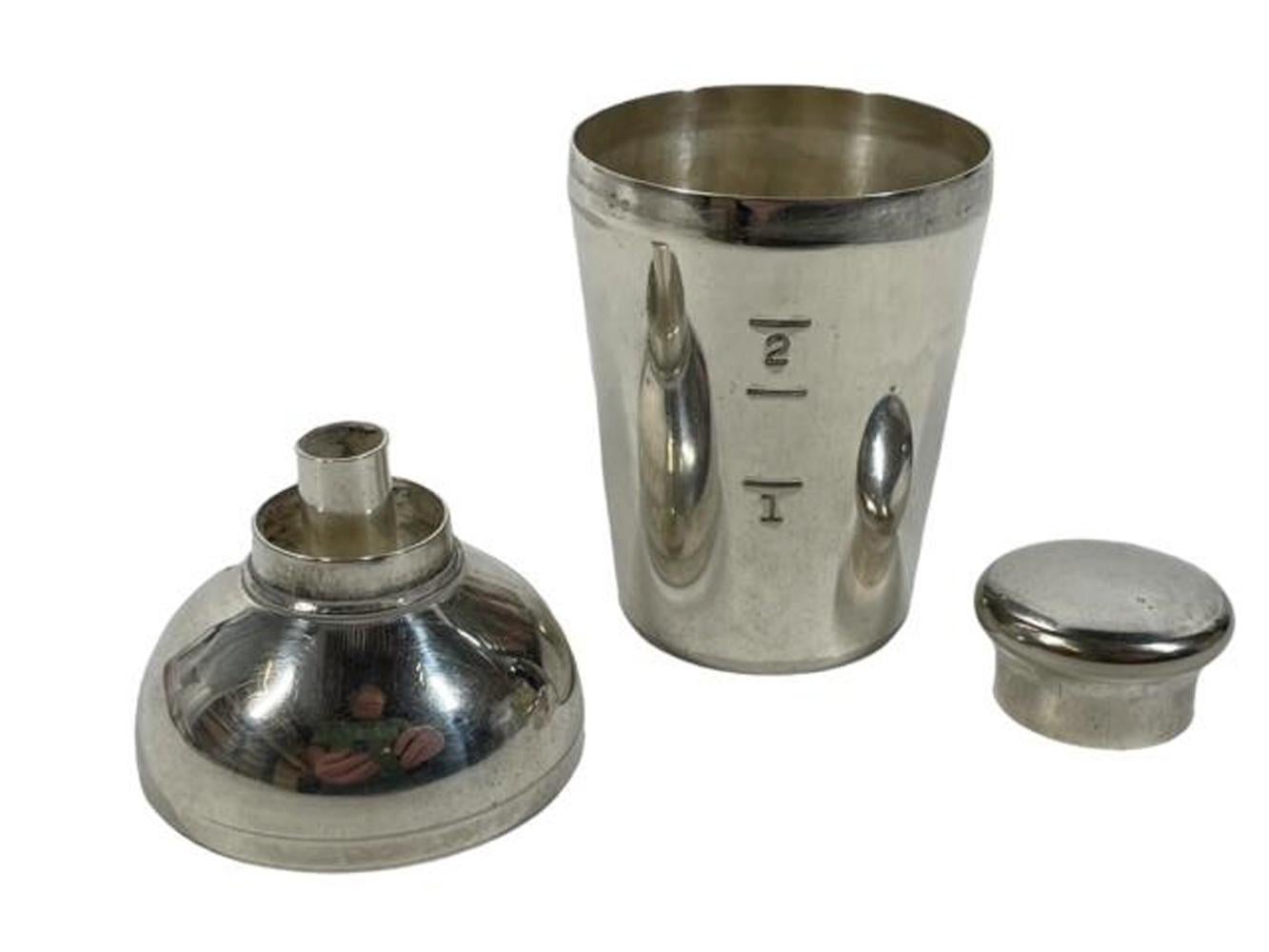 Silver plate combination bar tool by Napier Silver Co. in the form of a cocktail shaker, the bottom calibrated to measure spirits with the capped lid doubling as a funnel to fill a flask or bitters bottle.