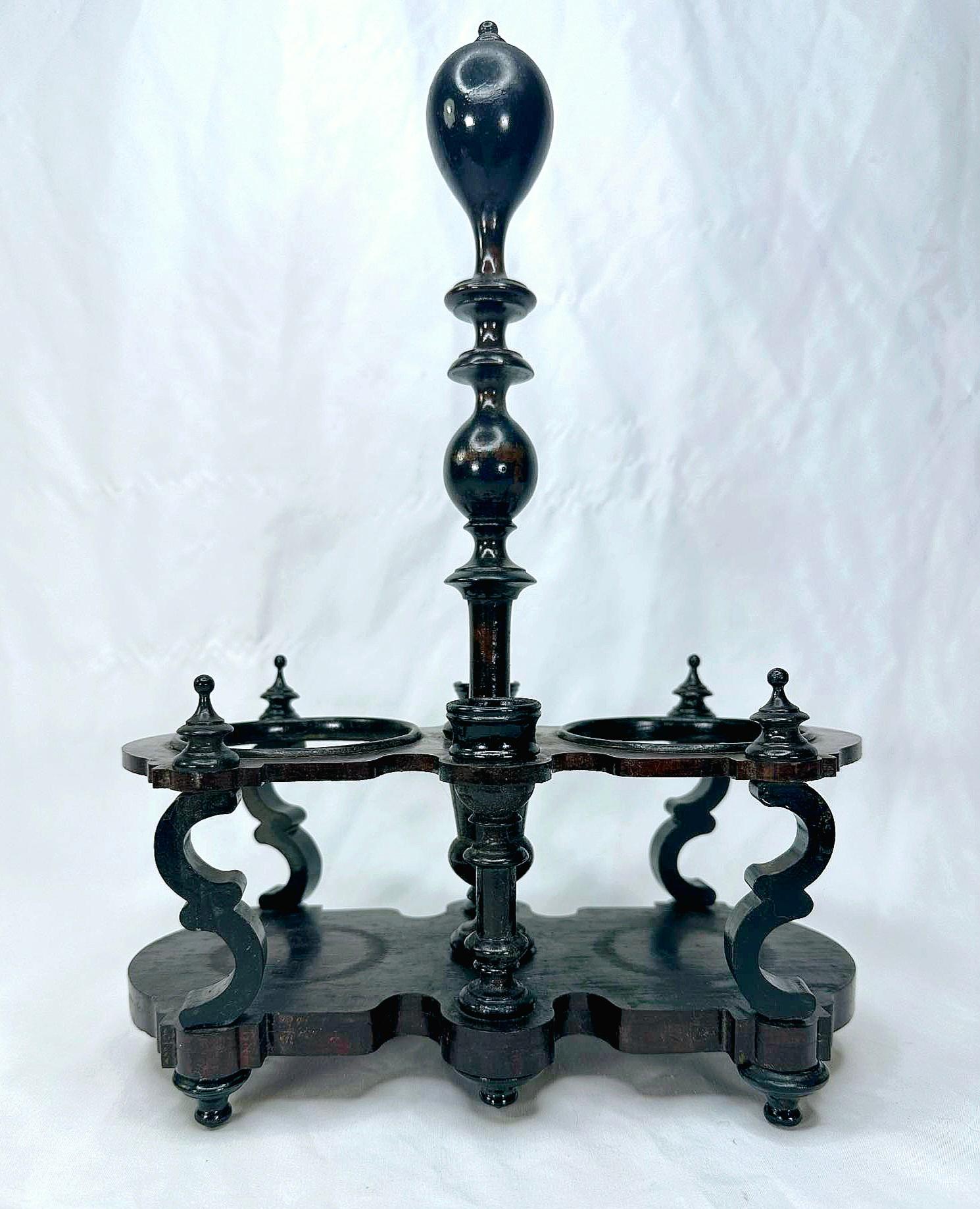 Napoleon the third 19th century turned wood oil and vinegar set, or vineagrier.
Set with two fluted crystal oil and vinegar pitchers.
Cut crystal stoppers.
Turned and ebonized stand.
Add some history and elegance from the Victorian era to your table