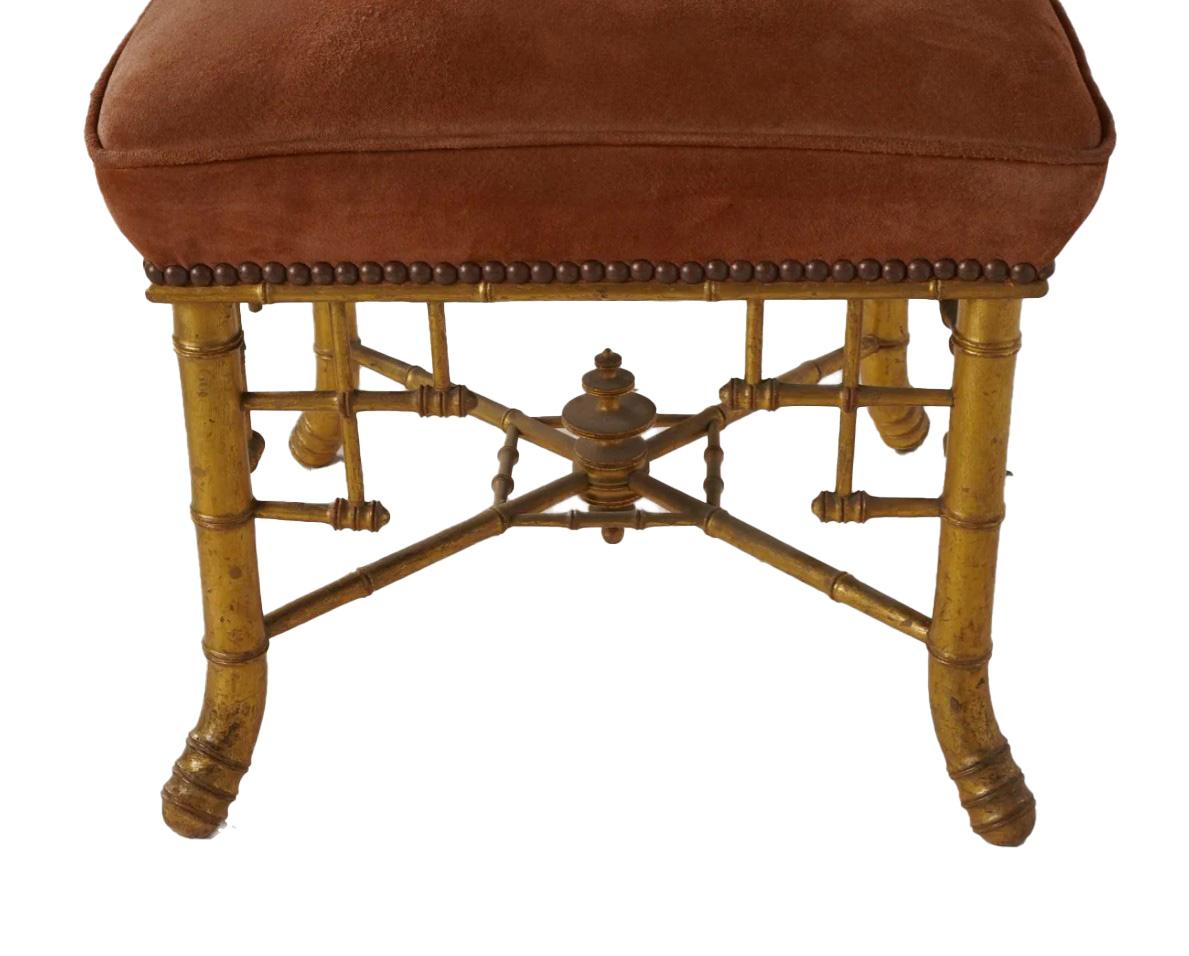 Introducing this truly exquisite piece – the Napoleon III Gilt Bamboo Stool with a rich terracotta-colored suede seat, a testament to timeless design and distinguished provenance. Originally placed by the renowned Michael S Smith in Jim Belushi's