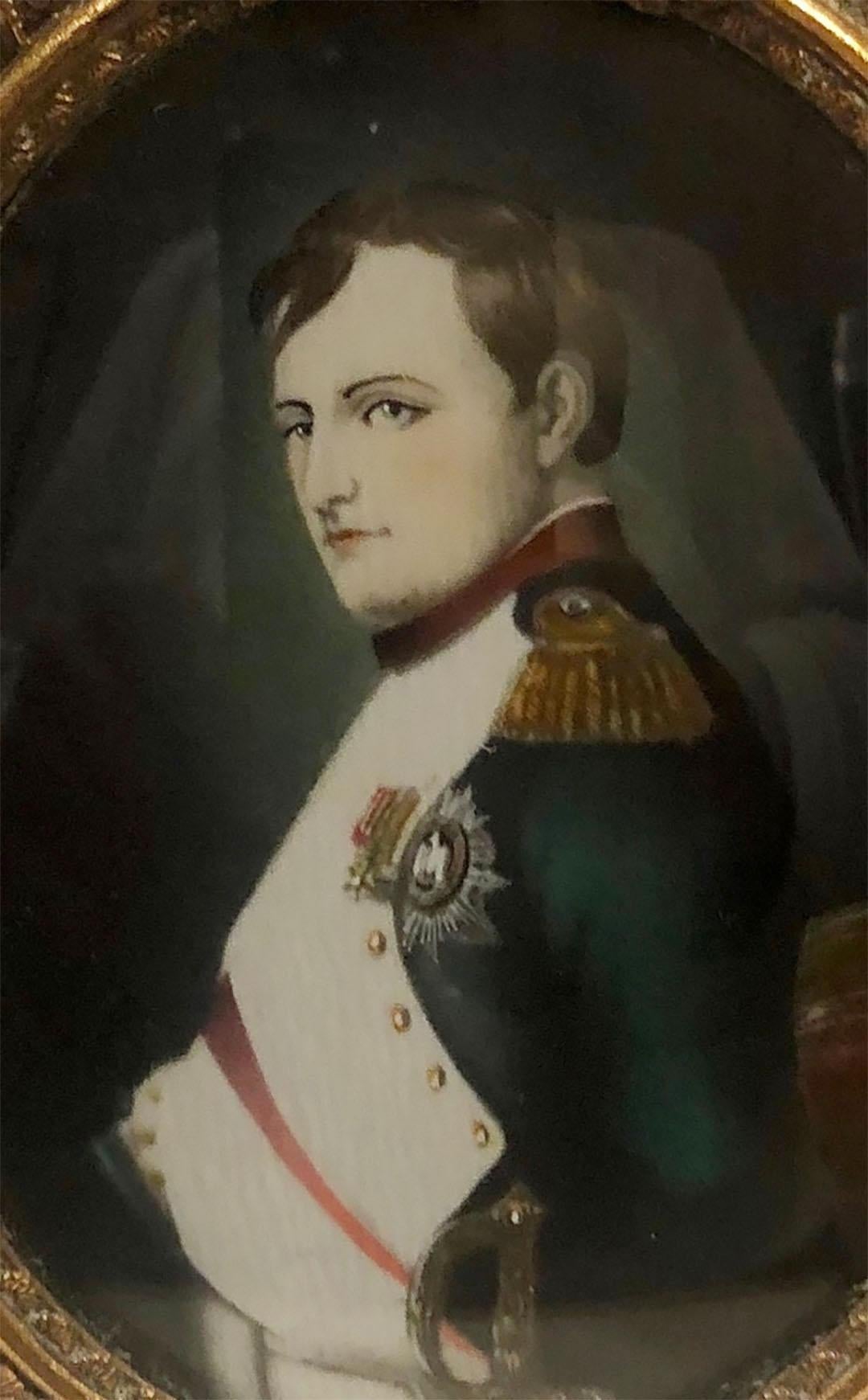 Napoleon Bonaparte on ivory with a an oval doré bronze frame with a bow at the top. Hangs but stands as well, it has an easel back. Signed but I can’t make out the signature. French, late 19th century. 