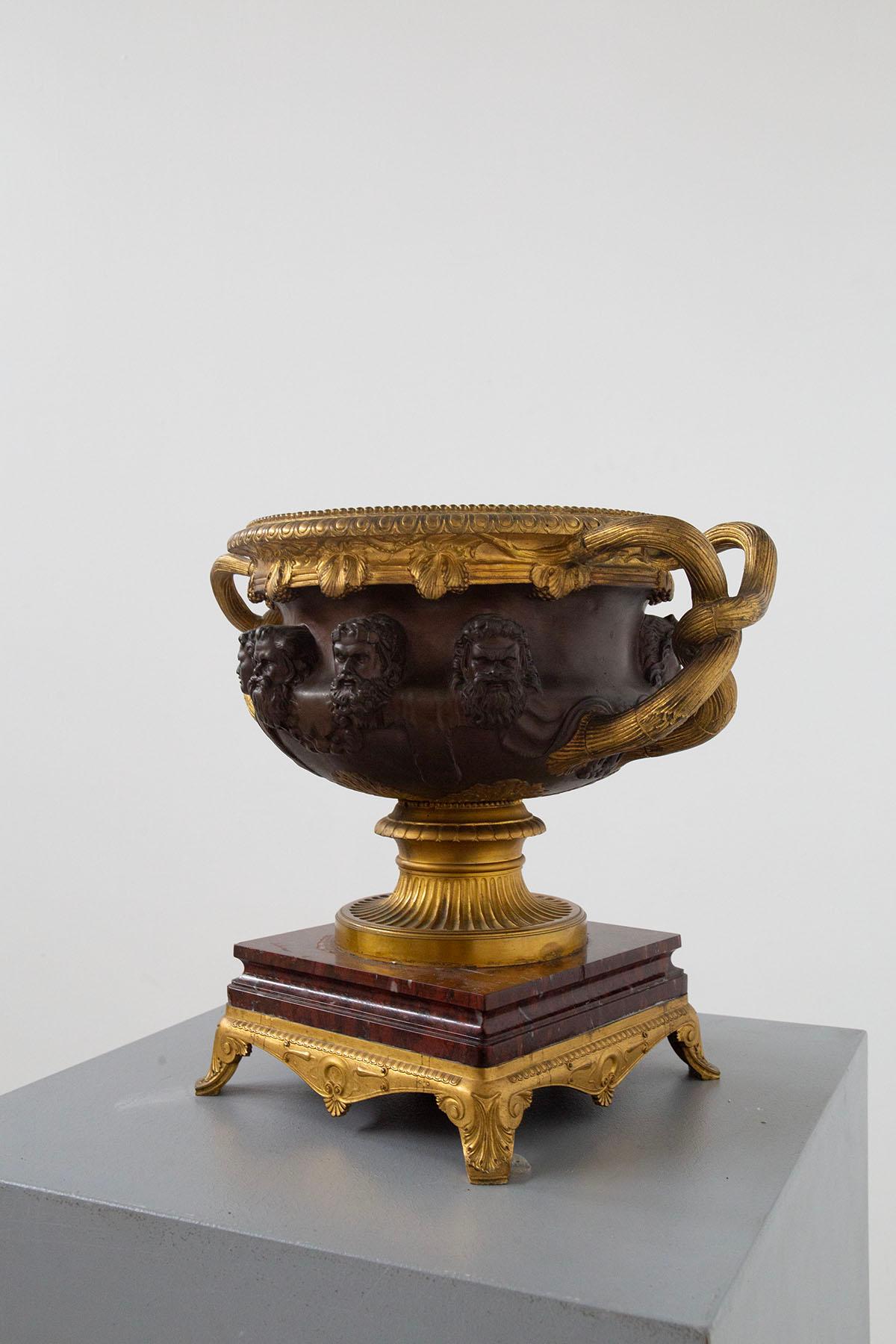 The cup or mug described is a beautiful piece by Ferdinand Barbedienne, a renowned French bronze sculptor and foundryman who lived between 1810 and 1892. Created around 1860 and known as the 'de Warwick' cup, it is a masterpiece of craftsmanship.
