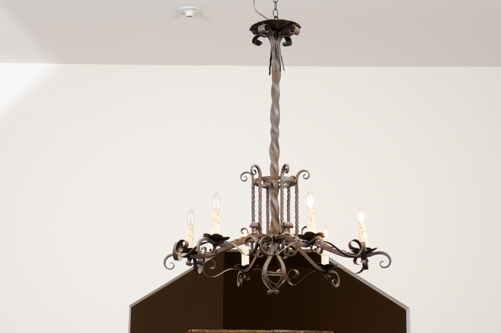 A French Napoléon III period six-light iron chandelier from late 19th century with scrolling accents and twisted patterns. Created in France at the end of emperor Napoléon III's reign, this iron chandelier features a twisted shaft supporting six