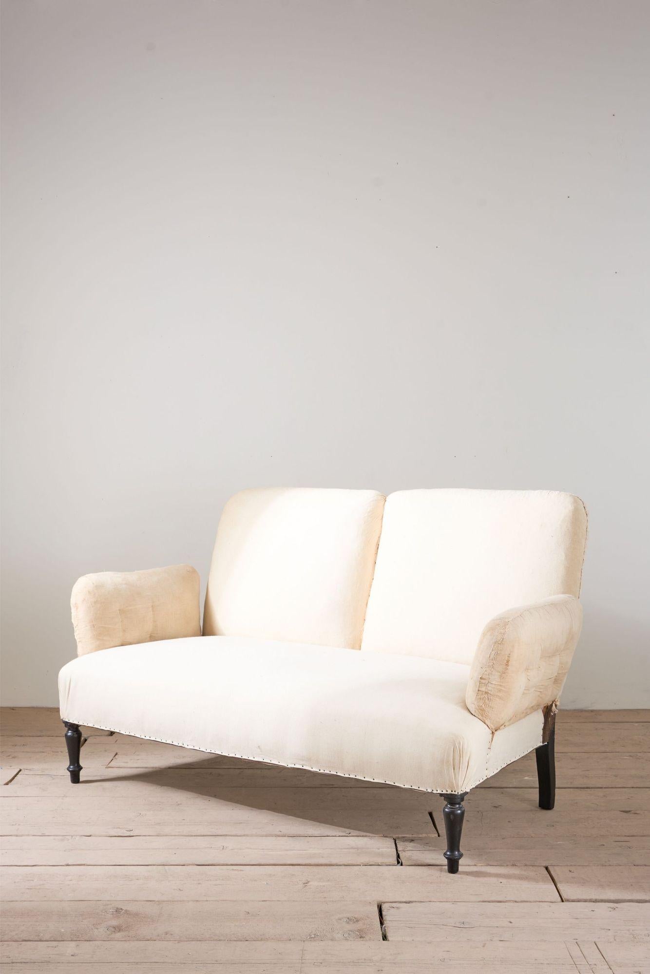 This is a very elegant Napoleon III pillow armed sofa. Neat 2 seater size that will work well in a living space or bedroom. Unusual design that always looking amazing when covered.

Measurements Height 88cm Width 153cm Depth 80cm Depth of seat 54cm