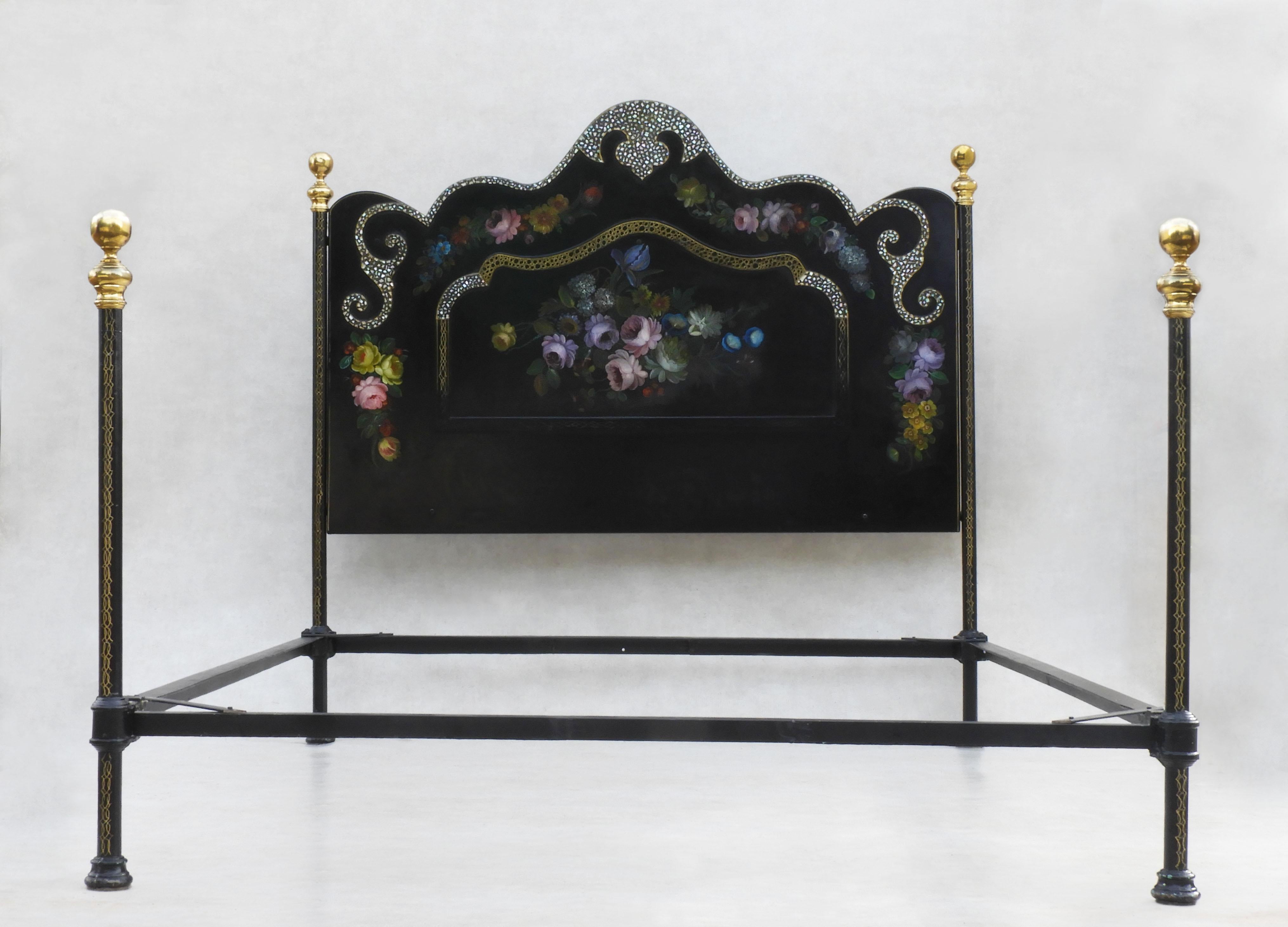 Charming Napoleon III bed with hand-painted florals and inlaid mother of pearl. 
Black Lacquered four-post bed with gilded detailing and brass finials, prettily adorned with beautifully painted flowers and iridescent mother-of-pearl detailing.