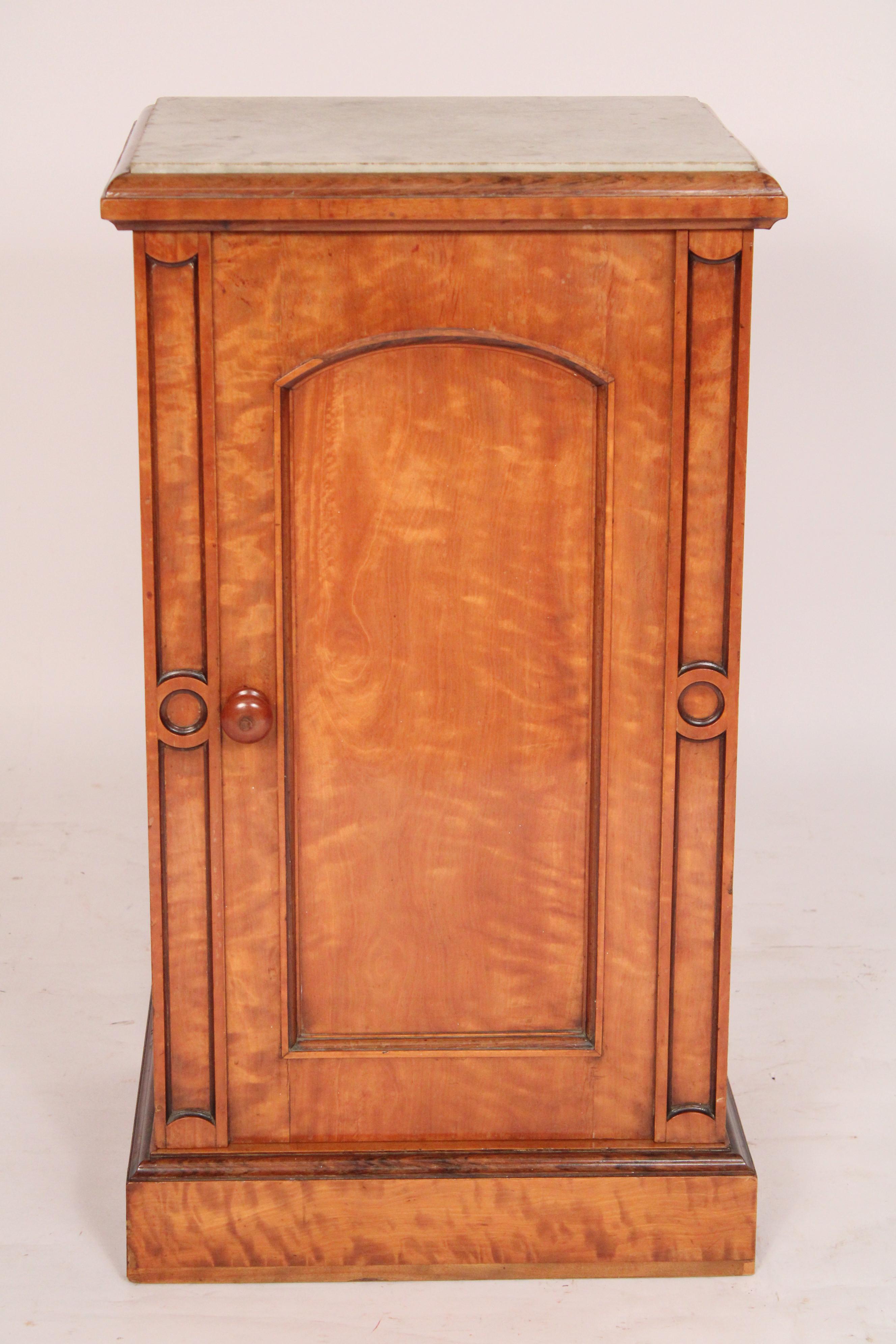 Napoleon III birch cabinet with marble top, circa 1880's. With a white marble top, molded top edges, a single arched door with a wood knob, resting on a plinth base. The birch with nice feathering.