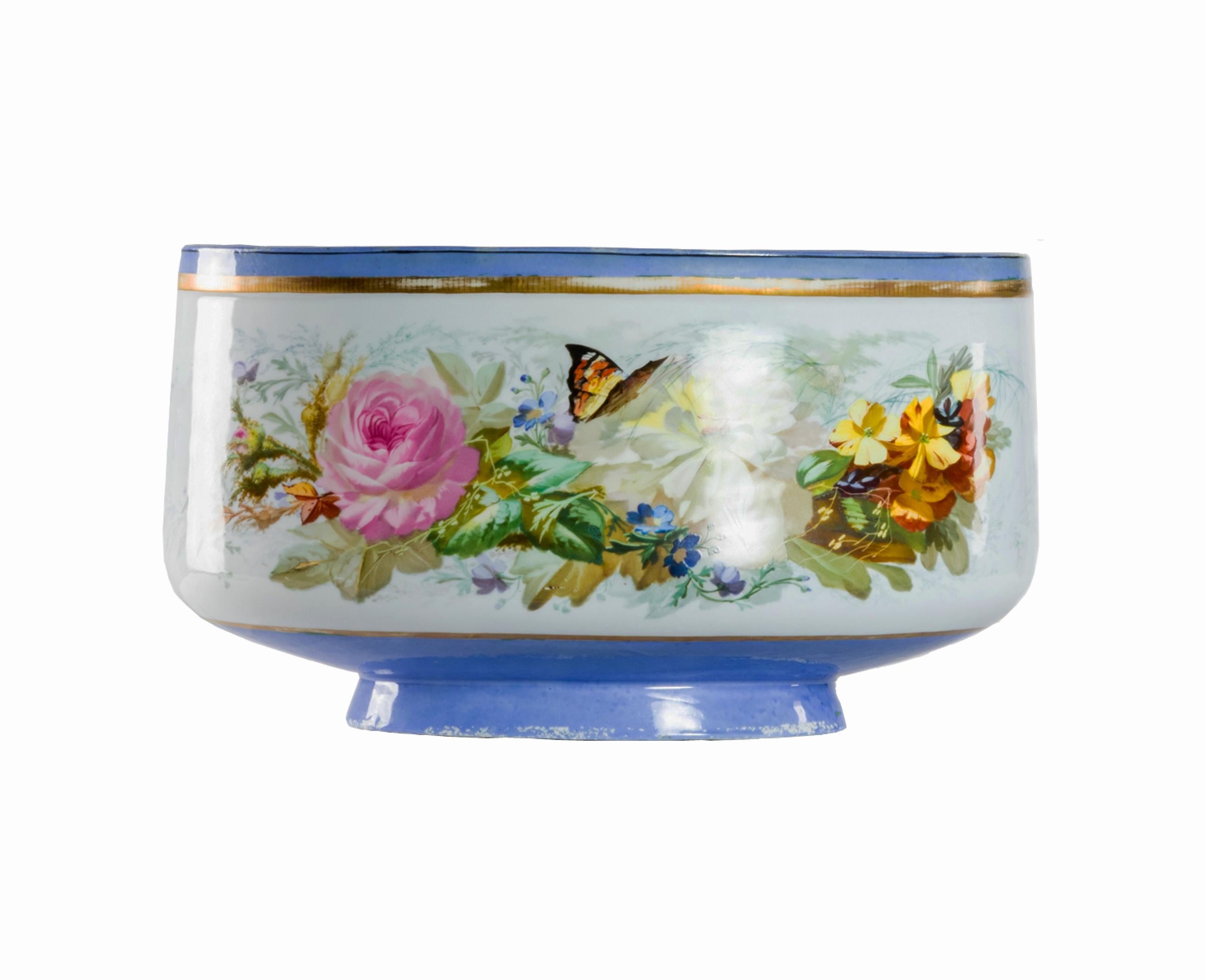 A 19th Century mist blue Limoges styled ceramic Jardiniere with a flower motif, butterfly and golden border from ‘Vieux Paris’ (1770-80) 