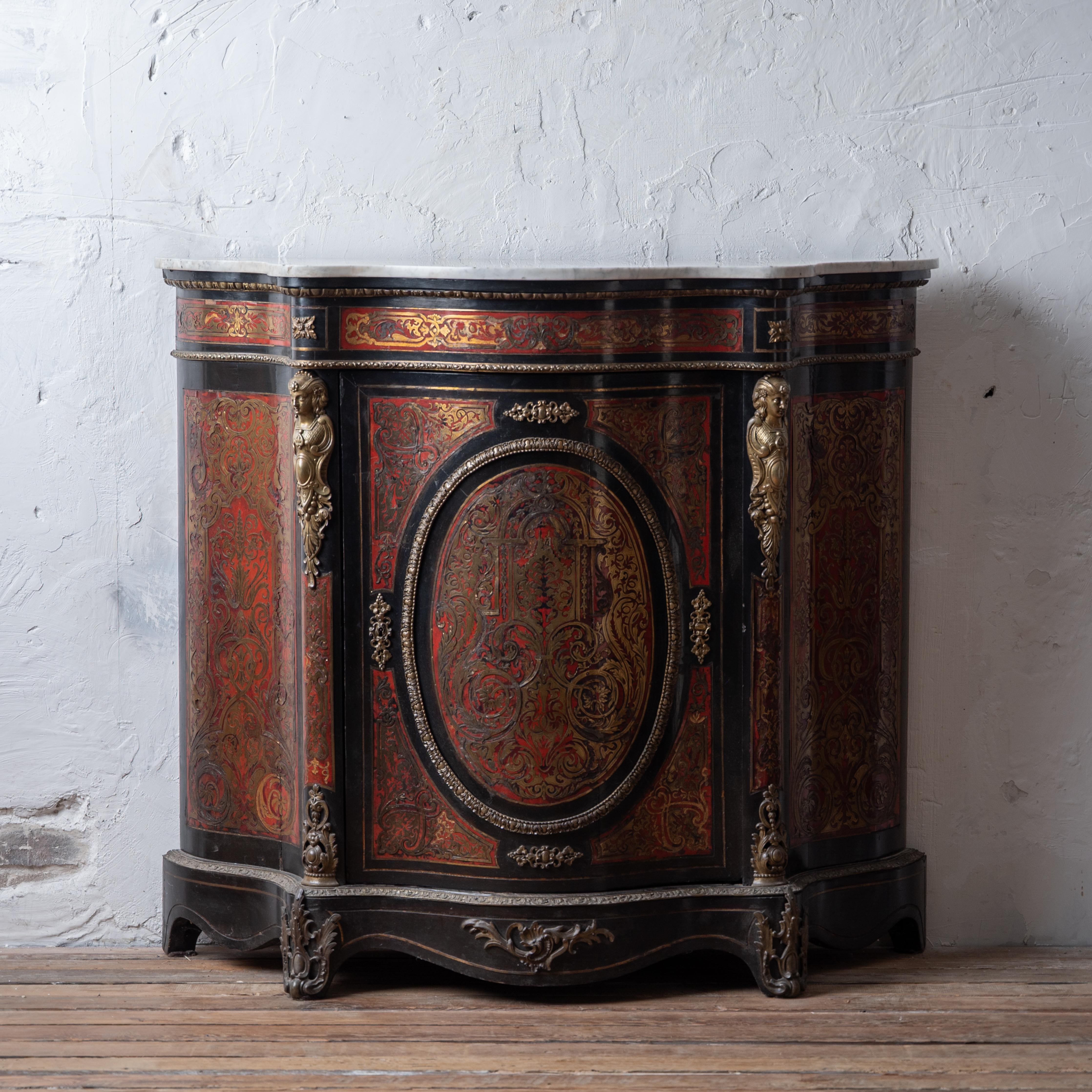 A Napoleon III ormolu-mounted ebonised, red tortoiseshell boulle marquetry side cabinet, circa 1860.



46 ½ inches wide by 16 ½ inches deep by 41 ½ inches tall 



Good with wear, age cracks, losses to cut brass inlay; wear to marble, small nicks,