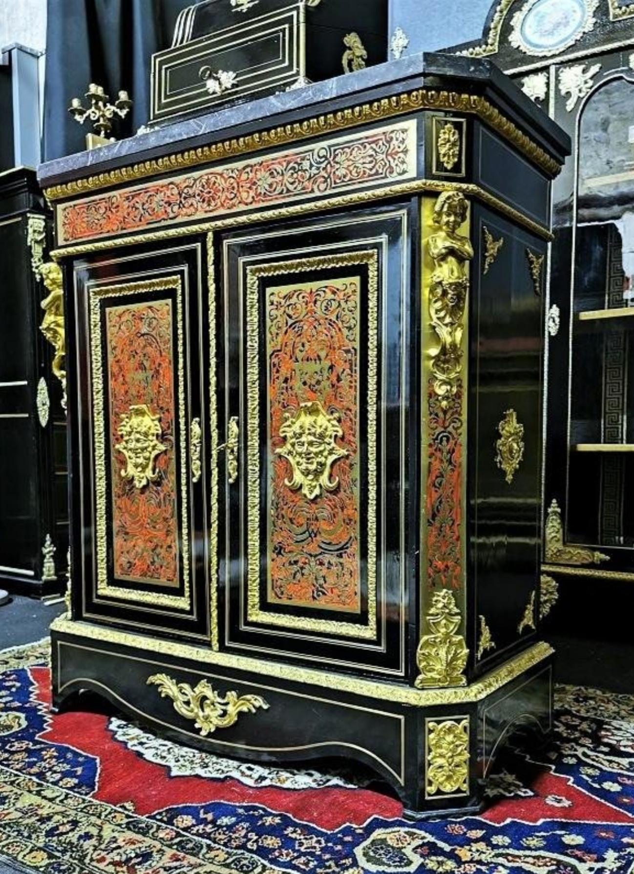Gorgeous Napoleon III cabinet with two doors in Boulle style marquetry of brass and tortoiseshell, with interlacing patterns and scrolls. Beautiful ornamentation of gilded bronzes with masks, caryatids, falls, spandrels, ingot molds, and angles.