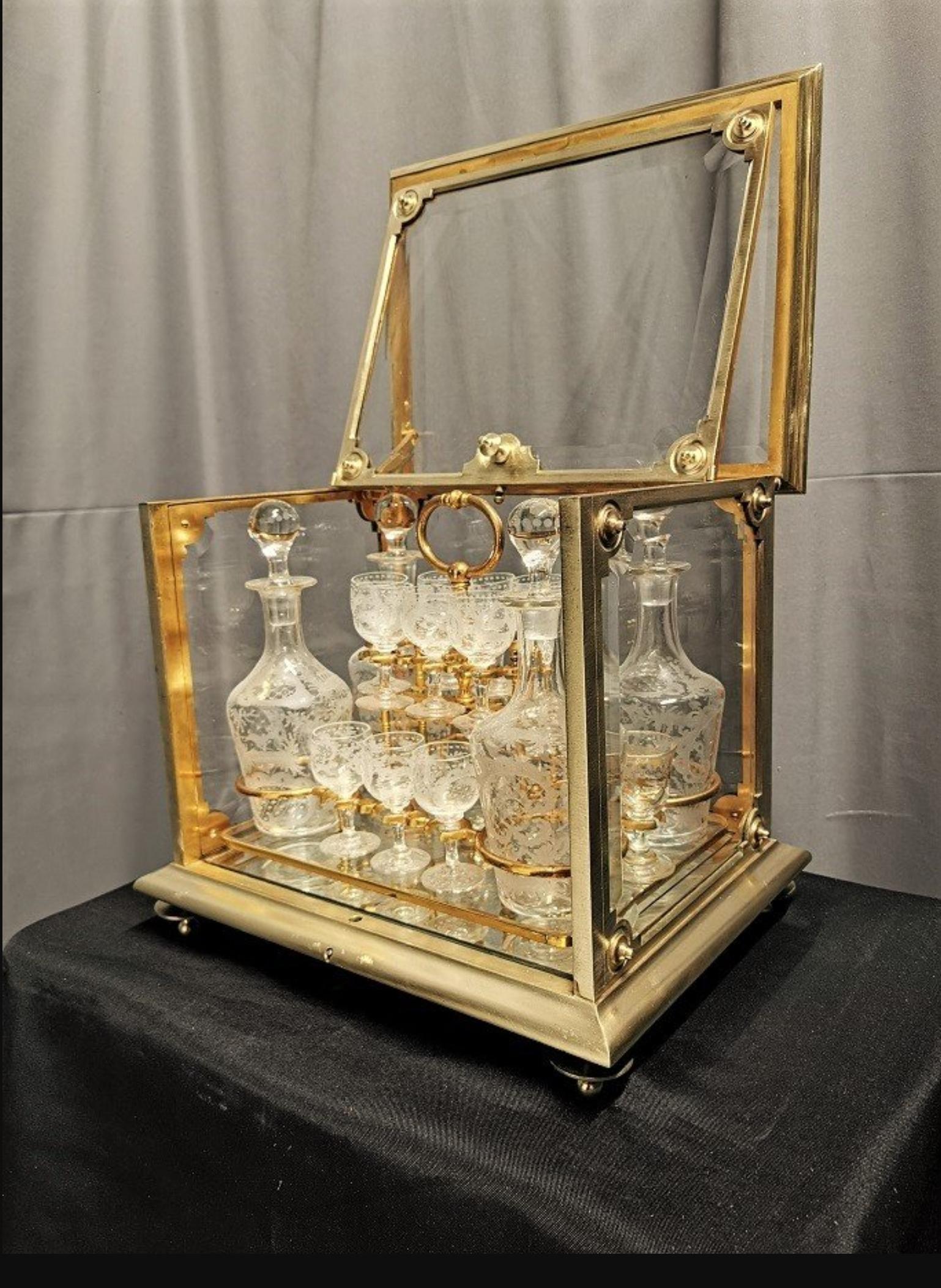 Stunning, impressive and really rare Napoleon III liquor cellar cabinet dry bar in Gilt Bronze and glass. Heavy and solid high quality materials.
Inside you will find 4 carafes bottles and 16 glasses in Baccarat crystal, beautifully
