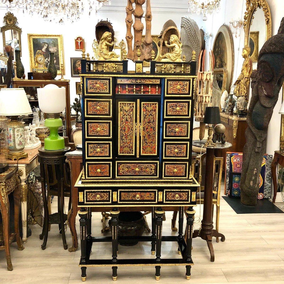 Presenting you this splendid cabinet in Boulle-style marquetry from the mid-20th century. It opens with ten small drawers, a large middle drawer, and two doors. It is further topped with a highly decorative gallery featuring gilt bronze colonettes
