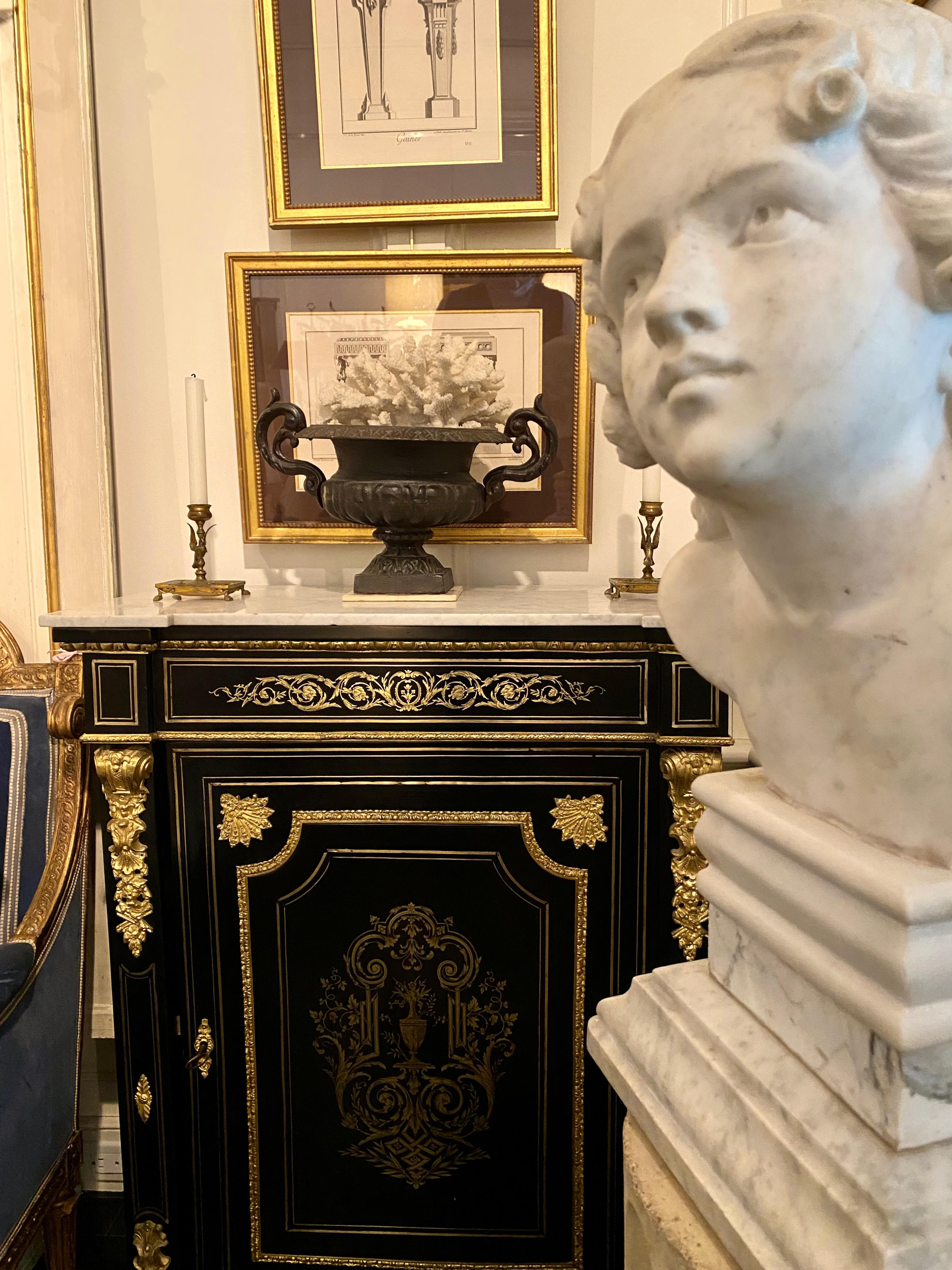 Napoleon III cabinet or Petite armoire, French 19th century

Ebonized, Boulle Style details, bronze inlay, gilt bronze mounts, marble top. Its neoclassical lines and ebonized gloss give it a Hollywood Regency chic.