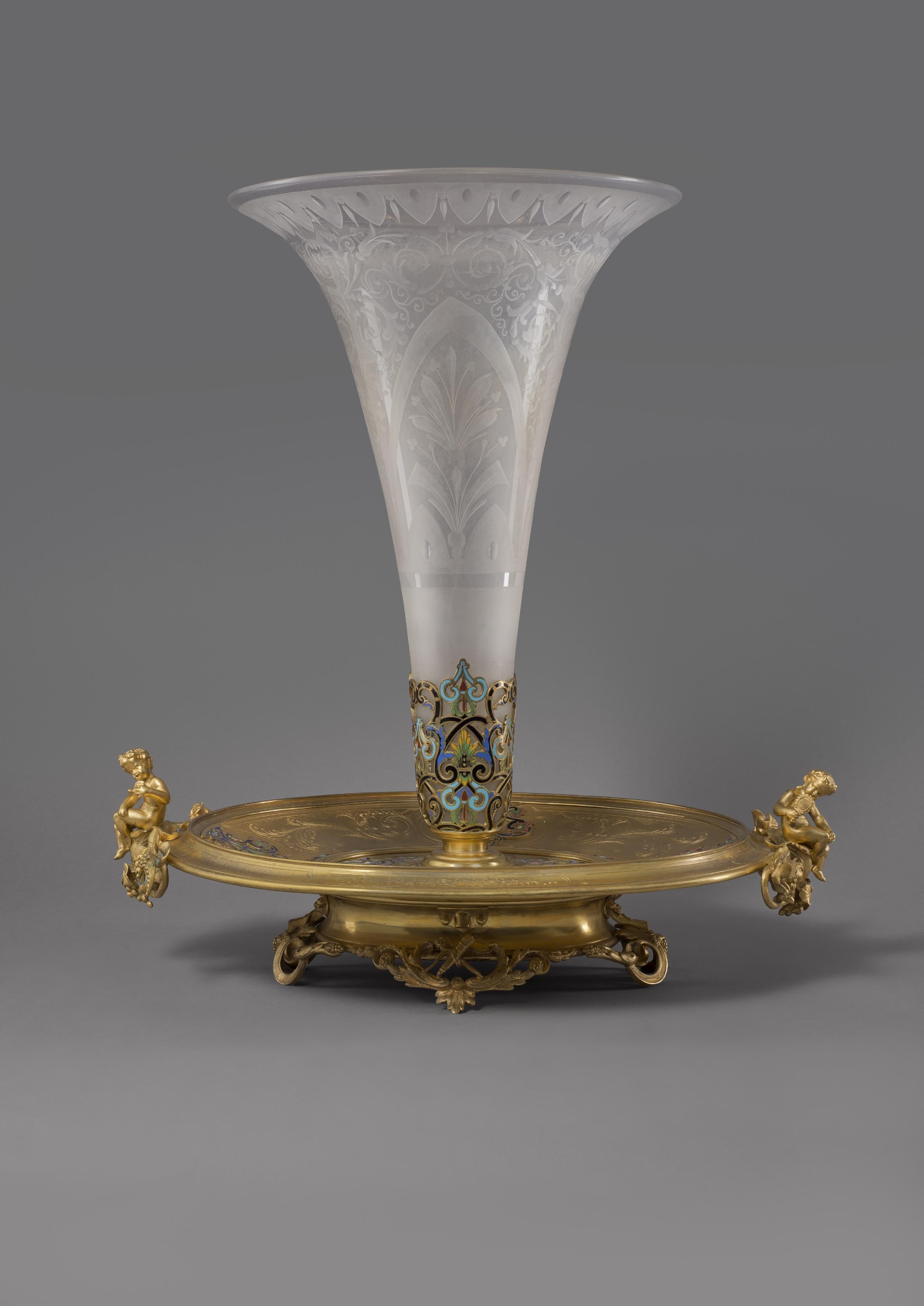 A Napoléon III gilt bronze and Champlevé enamel centrepiece, in the manner of Maison Alphonse Giroux.

French, circa 1870. 

This exquisite centrepiece has a frosted glass trumpet vase engraved with anthemion and supported by a neo-classical