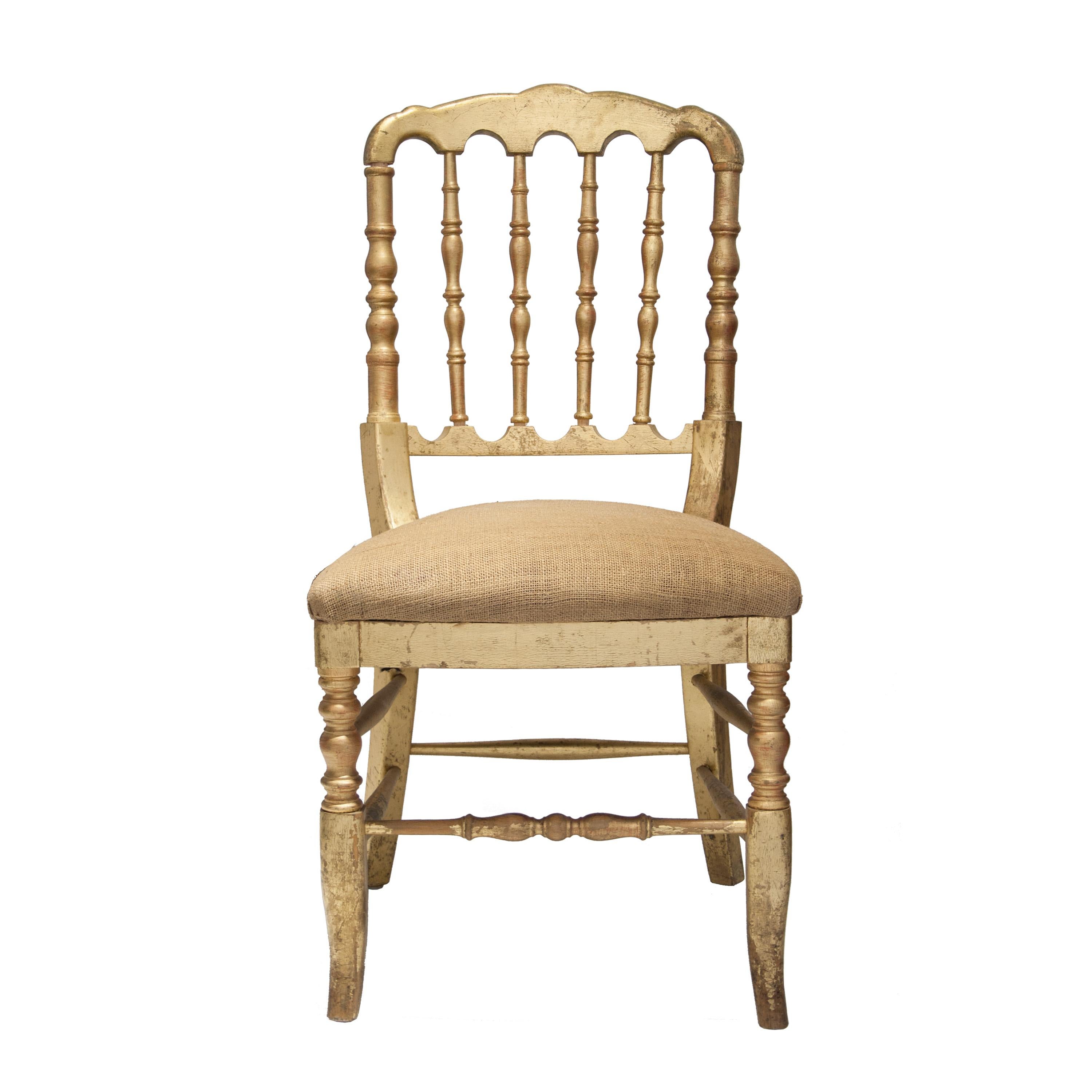 Set of 50 chairs, sold by units. Napoleon style solid wooden hand-crafted chairs. With turned bars in the back and turned legs. Gold leaf finished.