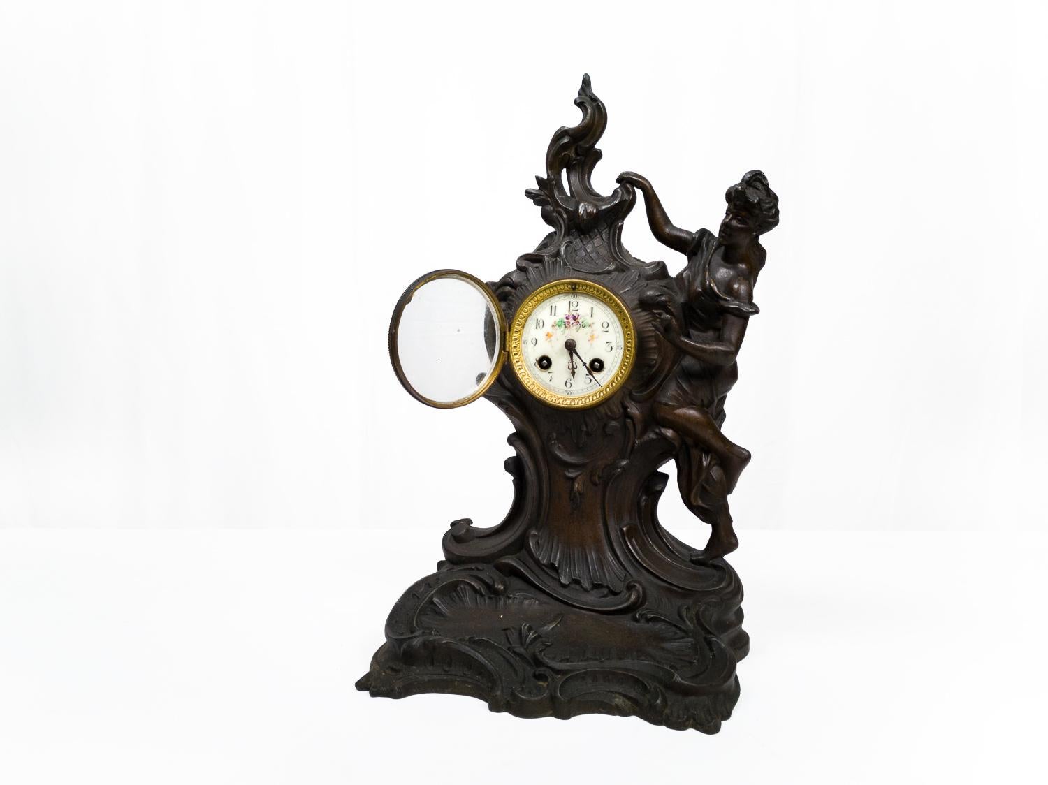 A Napolean III period mantel chimney clock with a mark on the letterhead of the mechanism «horlogerie suisse 23 Rue d'Alsace Lorraine Toulouse» in french Rococo Revival style. Mechanism reviewed recently and in working conditons. 
The emanel golden