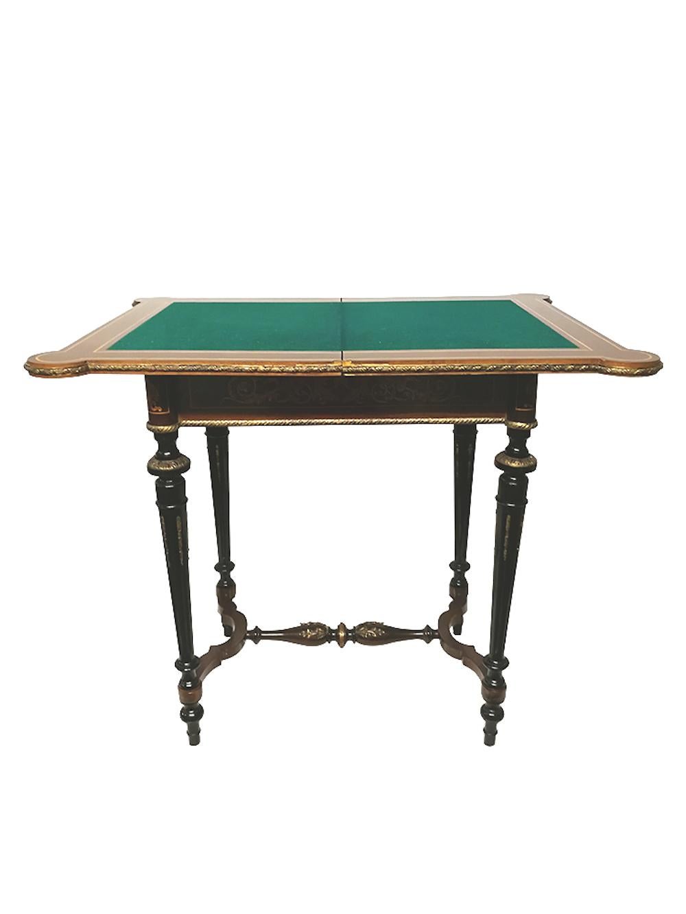 19th Napoleon III console marquetry game table with folding and rotating tabletop with inlaid foliage decoration of acanthus leaves, griffins, mascarons and snakes, ebonized legs and gilded bronze decorations on legs and tabletop edge. Green felt on