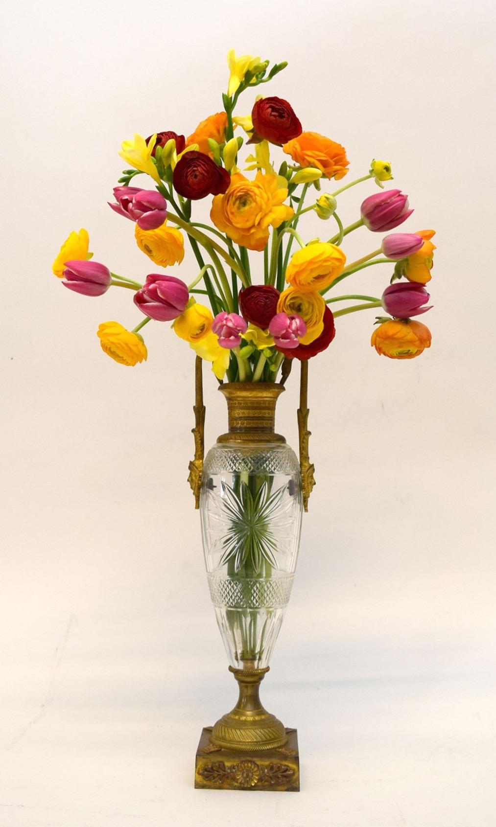In the early 19th century the typical, but fine flower vase was made of porcelain. The better ones were mounted in gilt bronze. But the most fashionable were of cut crystal and gilt bronze. The vogue for them began in France when Napoleon was
