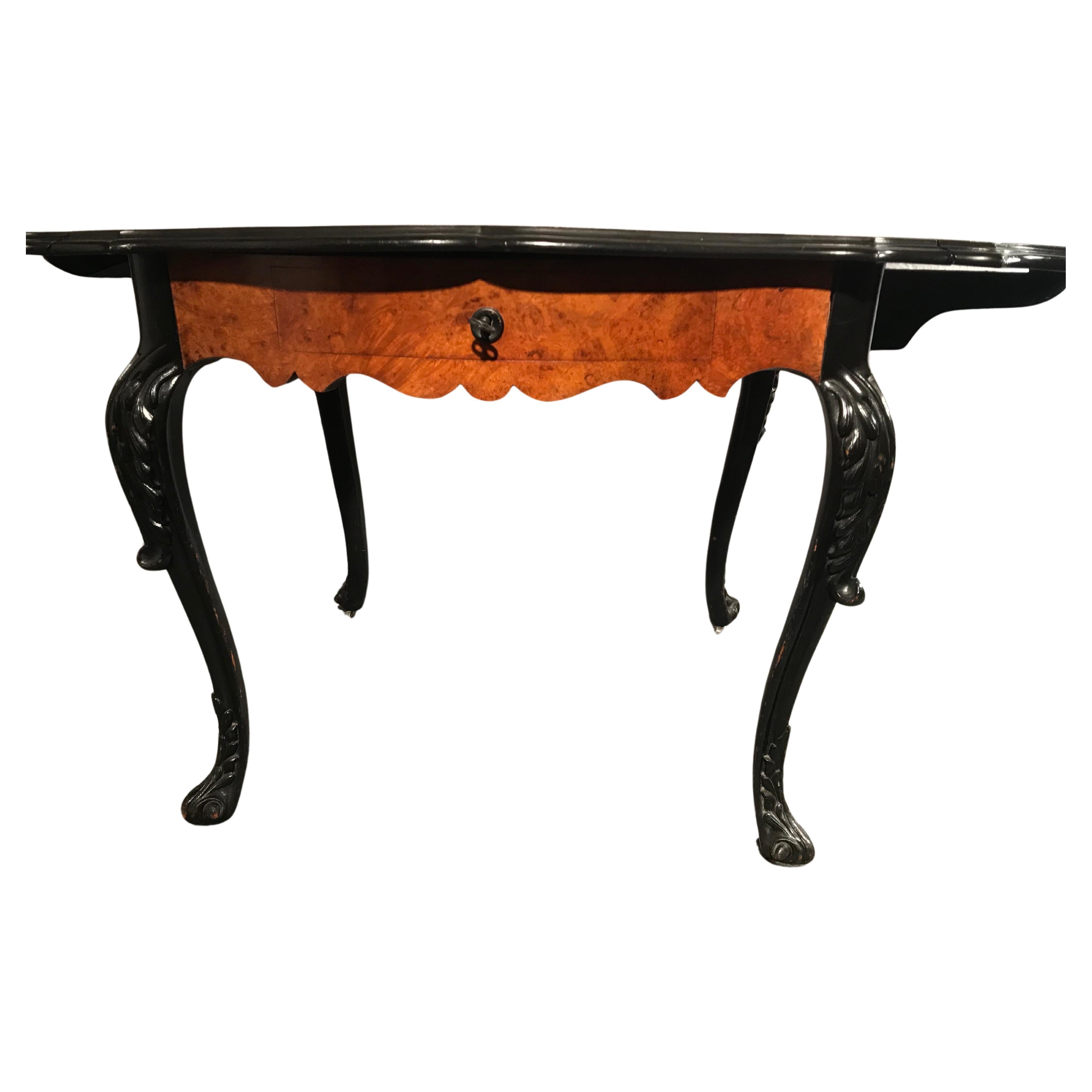 Discover an extraordinary side table or desk that traces its origins to the period between 1860 and 1870, originating from the artistic craftsmanship of Belgium. This unique piece stands gracefully on four curved legs adorned with hand-carved