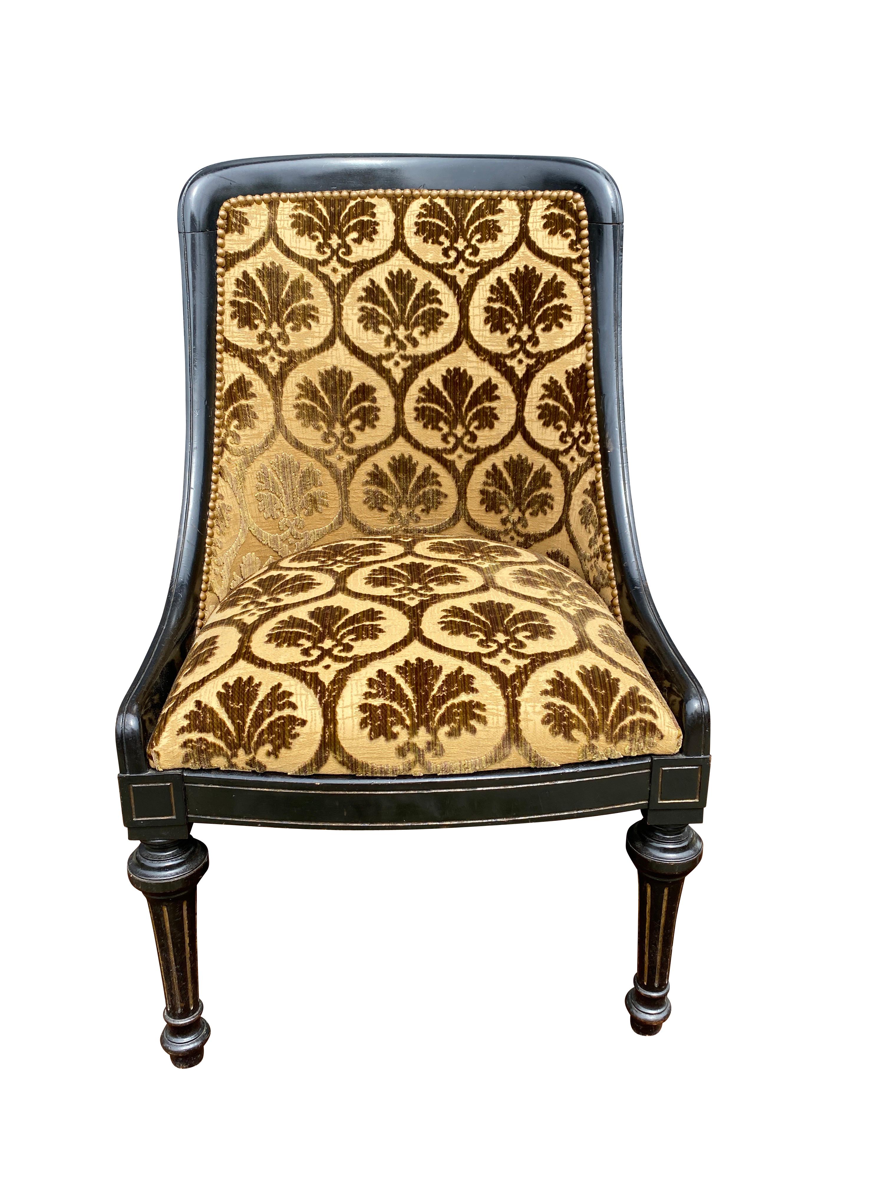 Slightly arched back upholstered in gold cut velvet raised on turned tapered fluted legs.