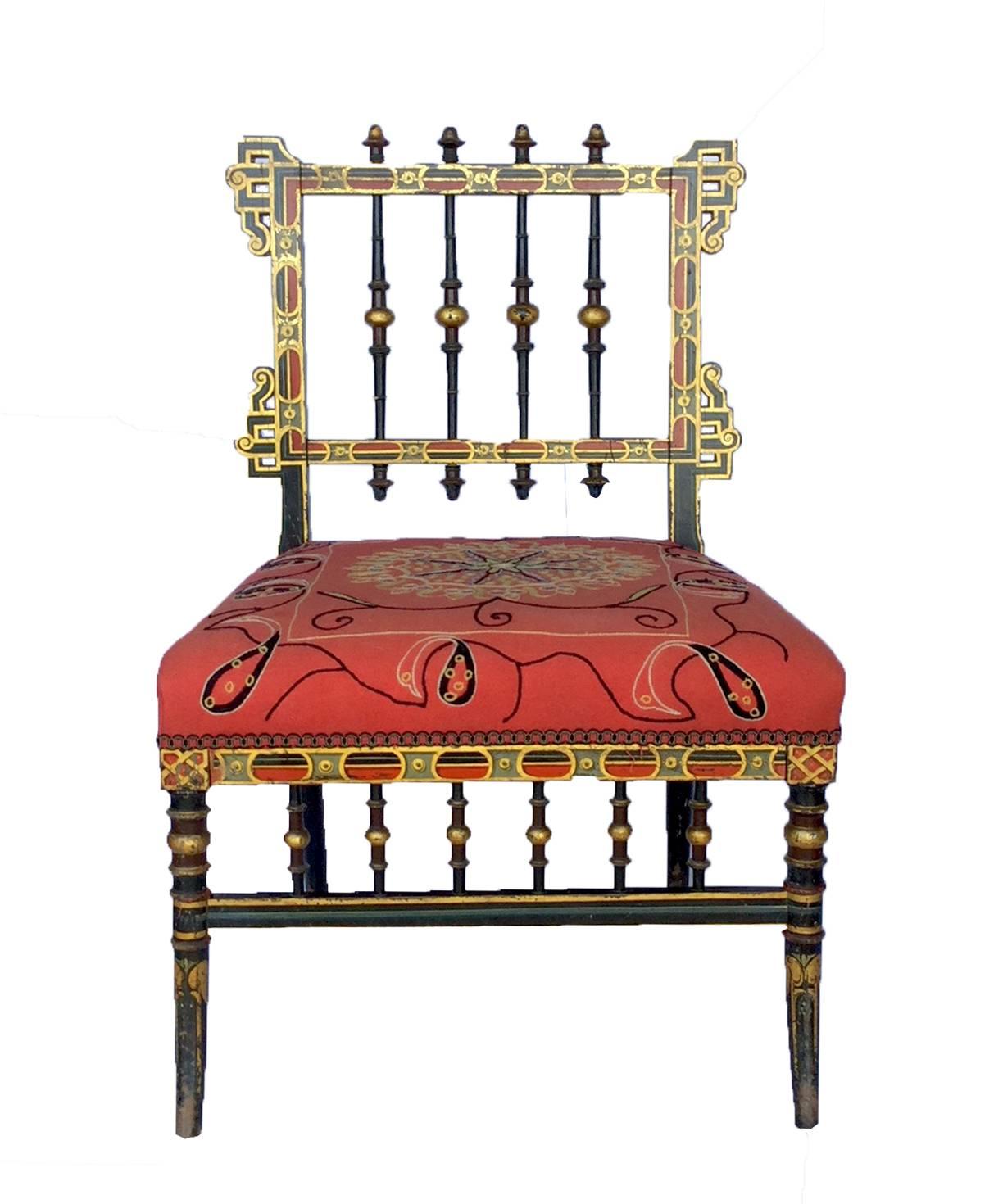 Napoleon III ebonized, polychrome and gilt-decorated slipper chair, circa 1850, beautifully upholstered in hand embroidered multi color fabric which coordinates with intricately painted and gold leafed carving.