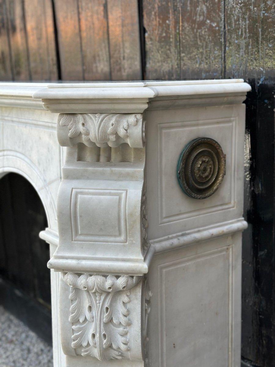 Imposing fireplace in statuary white Carrara marble, lintel decorated with the number LG, it is restored on the right and on the left. fireplace dimensions: 74.5 x 124cm.