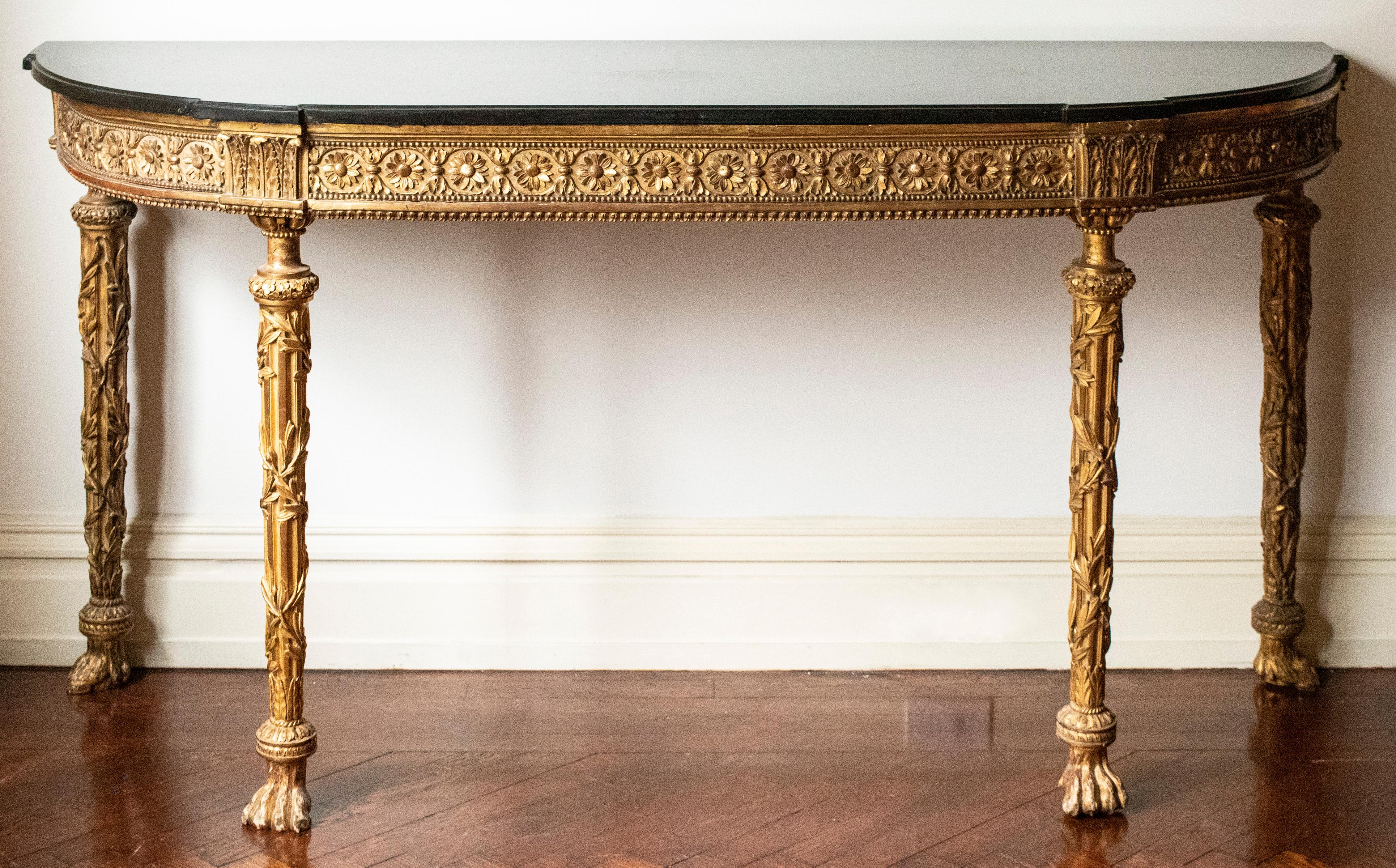 Napoleon III French Second Empire pair of marble top giltwood console tables, floral and foliate carved frieze over carved and fluted legs terminating in paw feet. 32.5