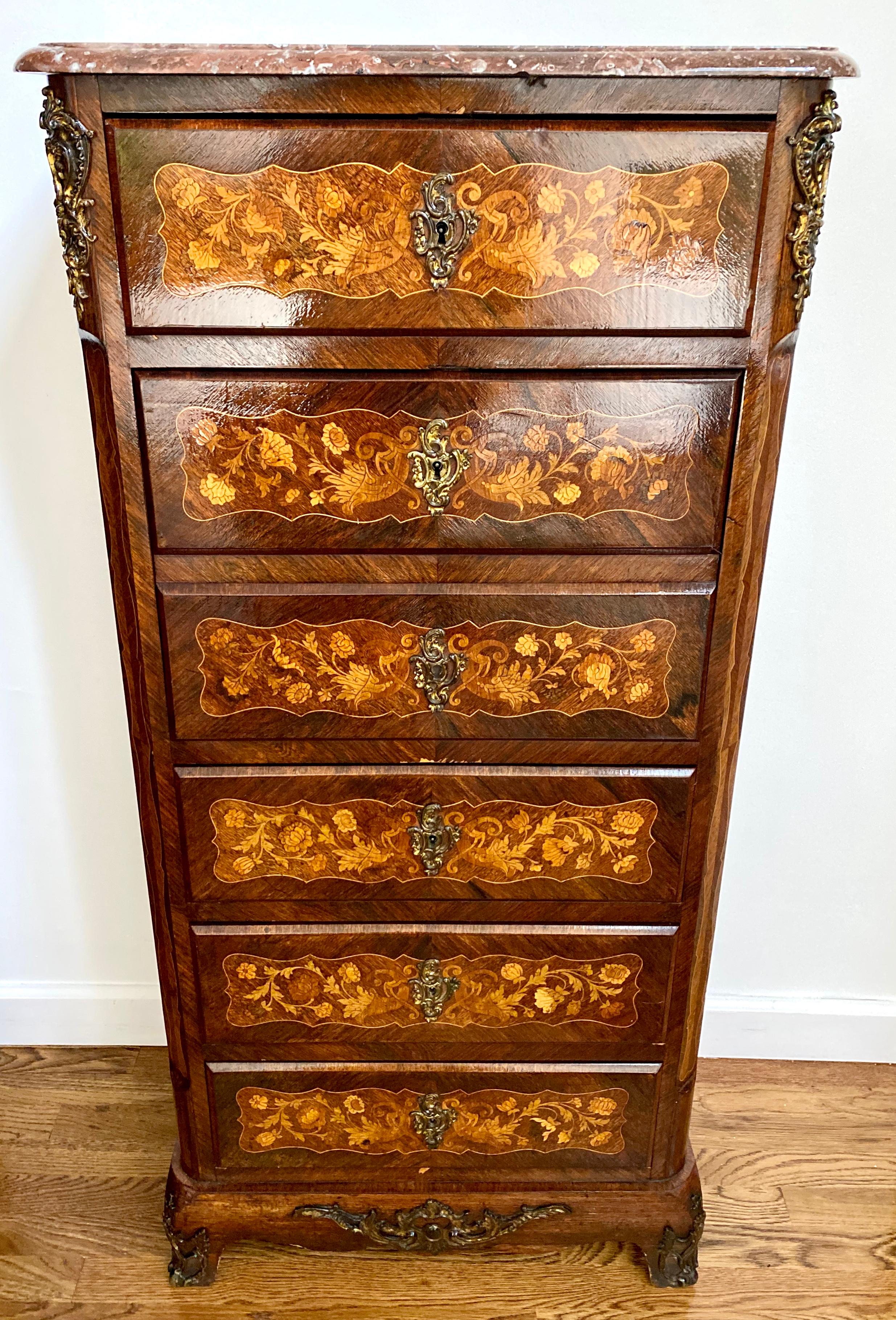 19th century Napoleon III French secretary (secretaire) chest of drawers in fine mahogany rosewood Inlaid marquetry. It has a grey marble top complete with its original in gilt bronze, circa 1870.
  